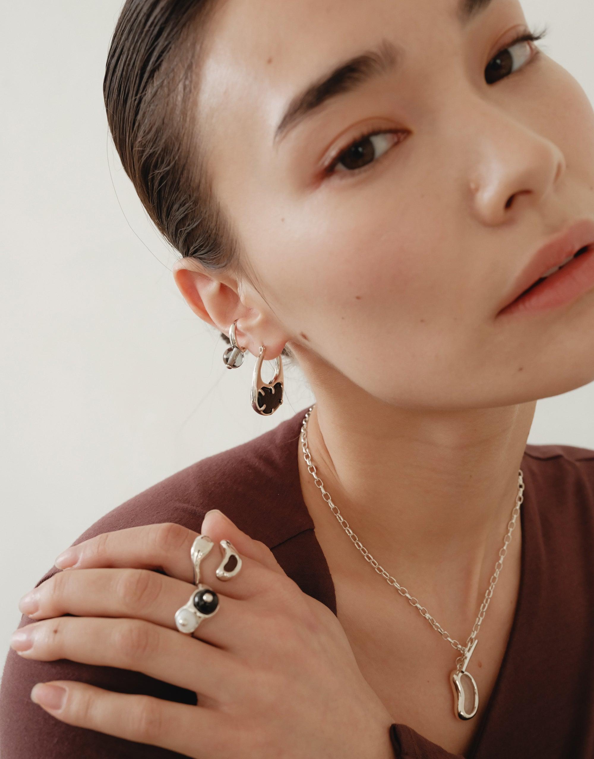 Sprout Ring showcased on a woman's finger, featuring organic curves inspired by legumes, highlighting CLED's eco-conscious design ethos with repurposed materials.