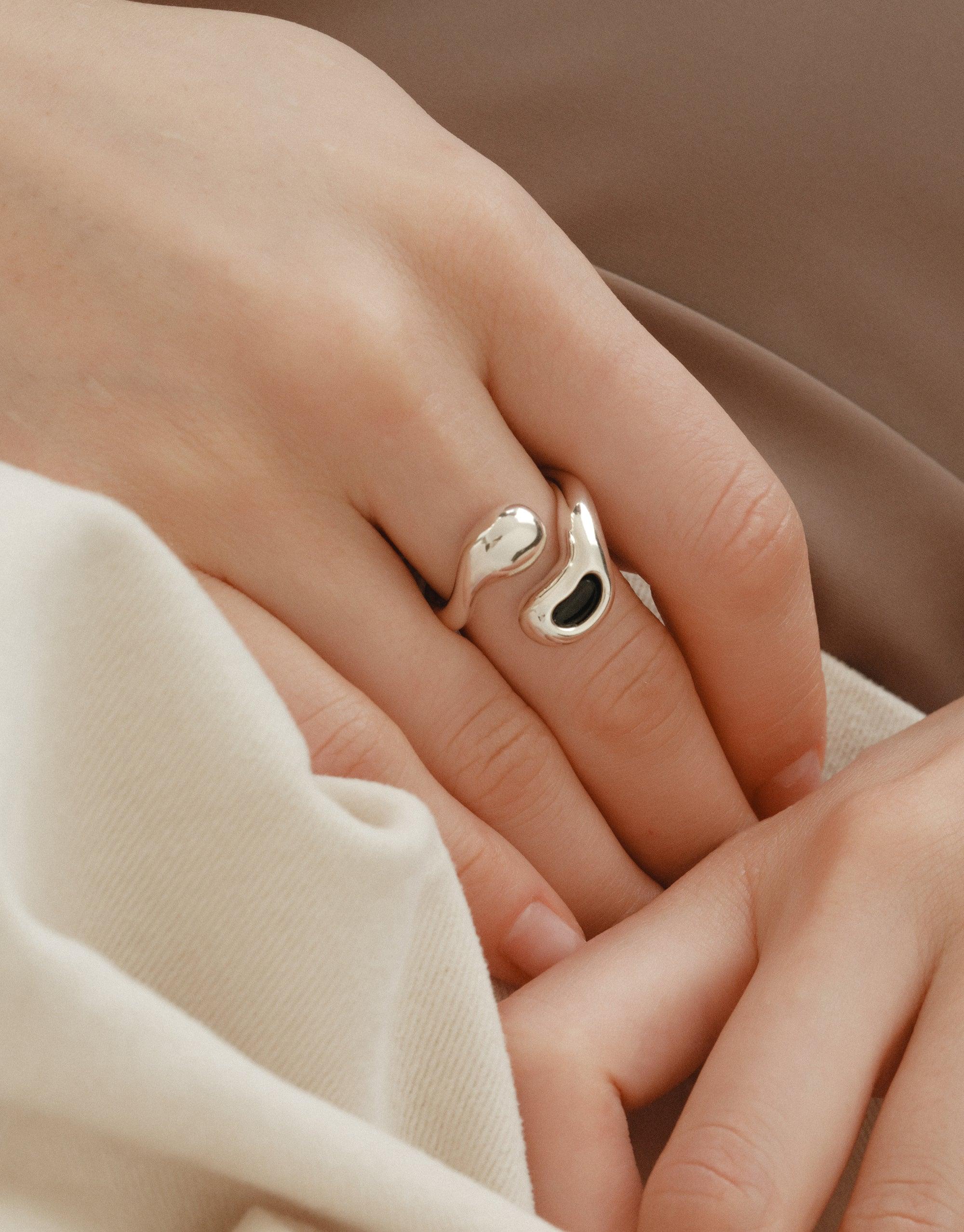 Sprout Ring with black stone on woman's hand, featuring an organic design inspired by legumes