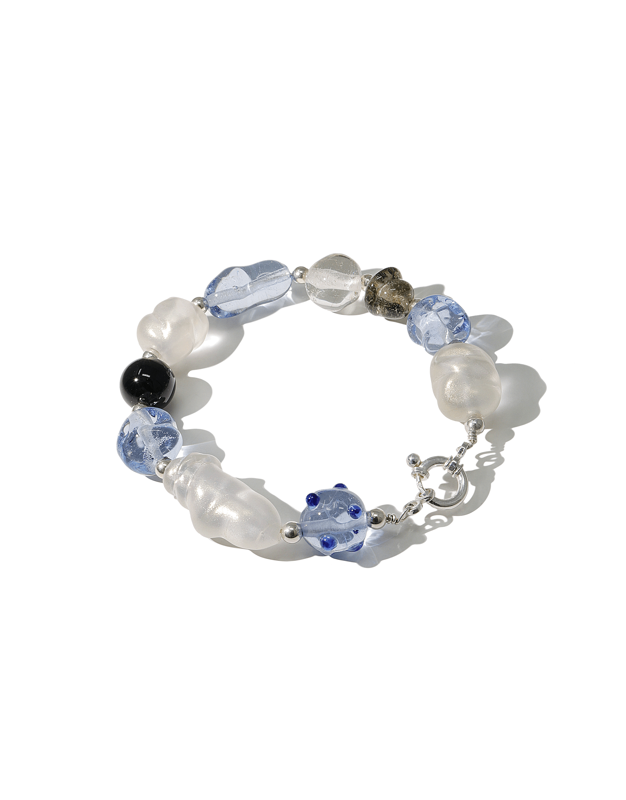 Blue Pearl Bracelet featuring multi-colored glass beads in various shapes and sizes, including blue, clear, and white, strung on a silver chain. Handcrafted eco-friendly jewelry piece with a unique and elegant design. CLED