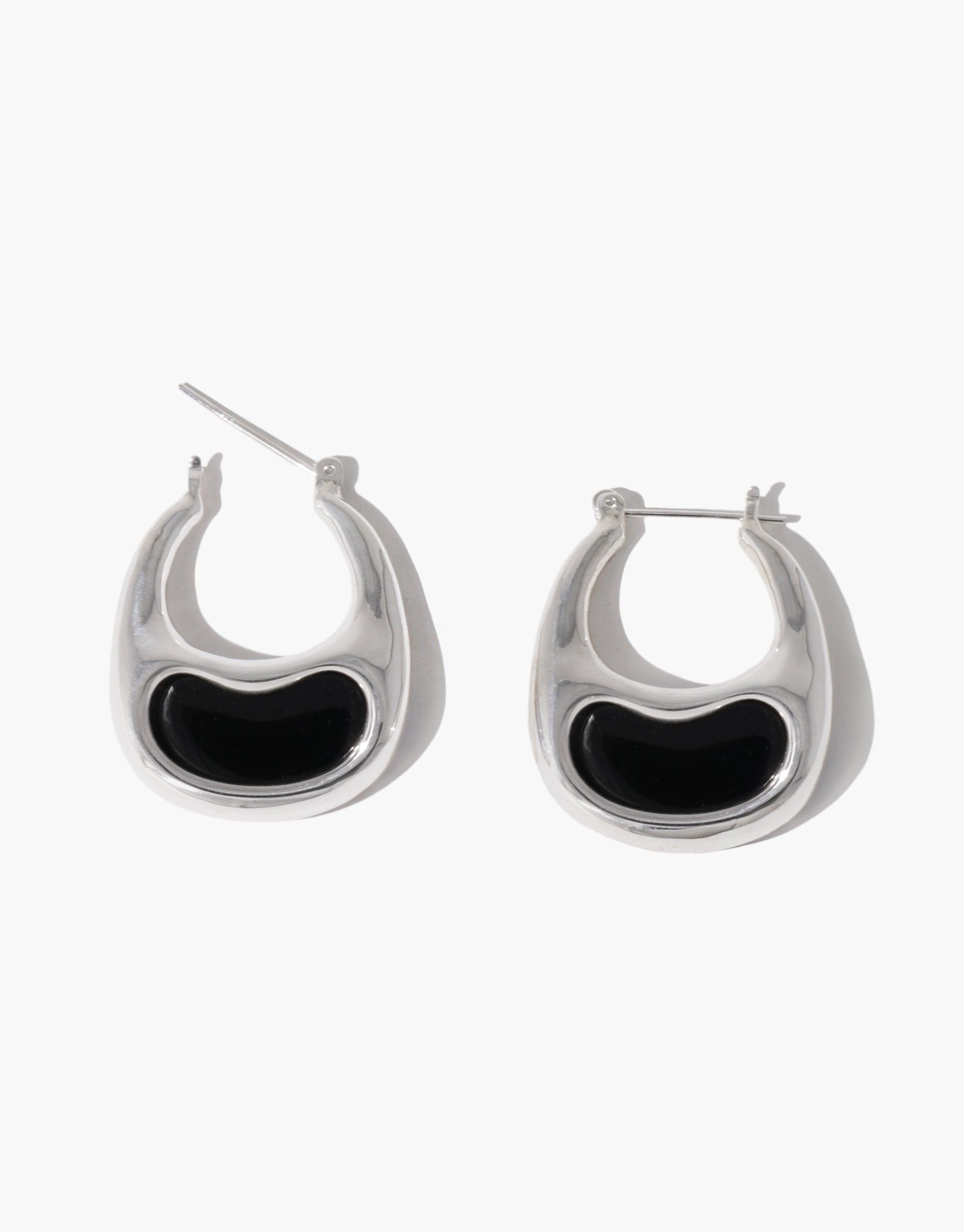 Sleek silver hoop earrings with black inlay, resembling bean-shaped design. Elegant and modern jewelry piece inspired by nature's organic forms. Bean Hoop Earrings | Large, showcasing contemporary style and craftsmanship. CLED