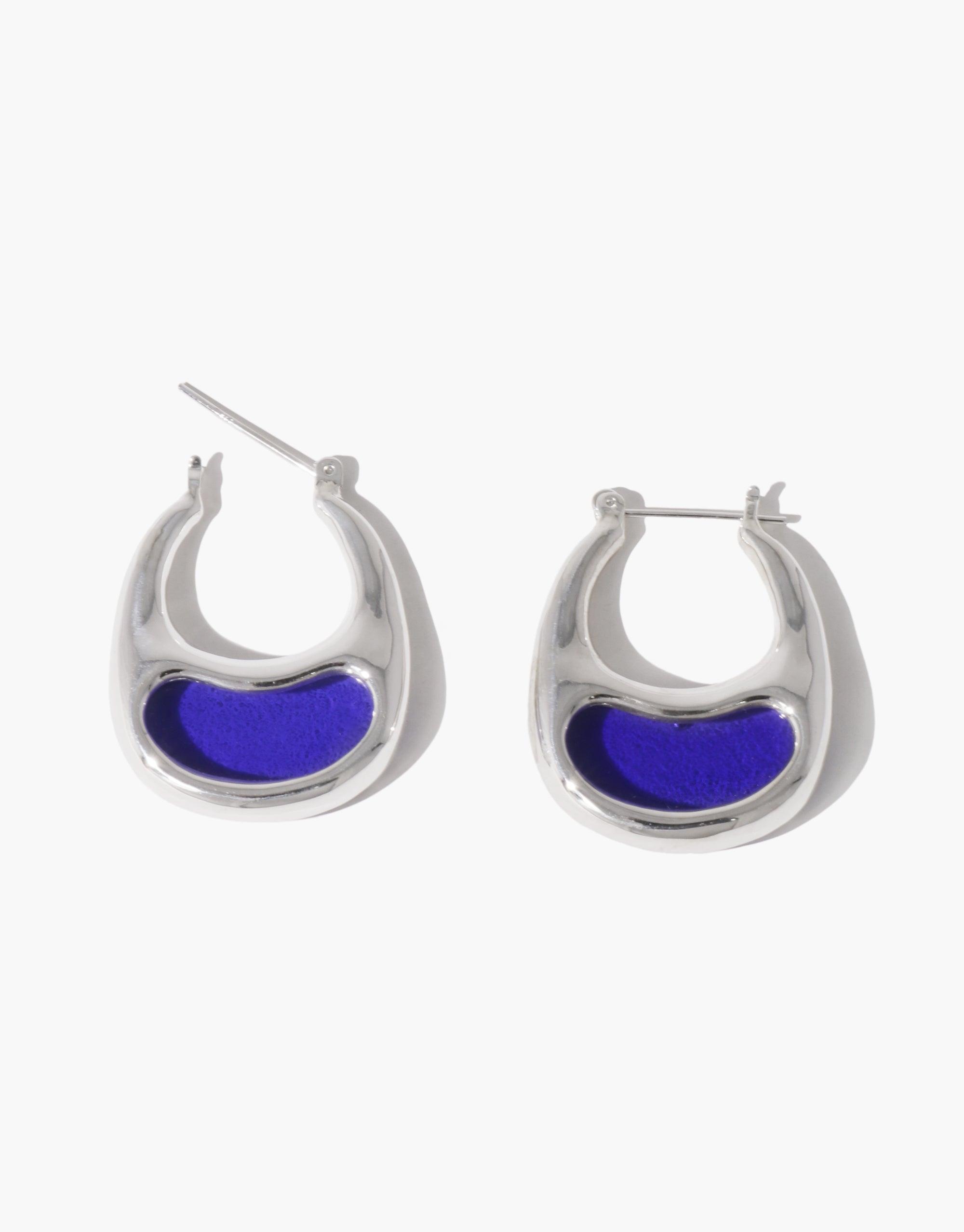 Silver hoop earrings with blue enamel inlay, inspired by bean shapes. Sleek and modern design showcasing natural curves and organic forms. Elegant and eye-catching accessory for stylish wear. Bean Hoop Earrings | Large by CLED.
