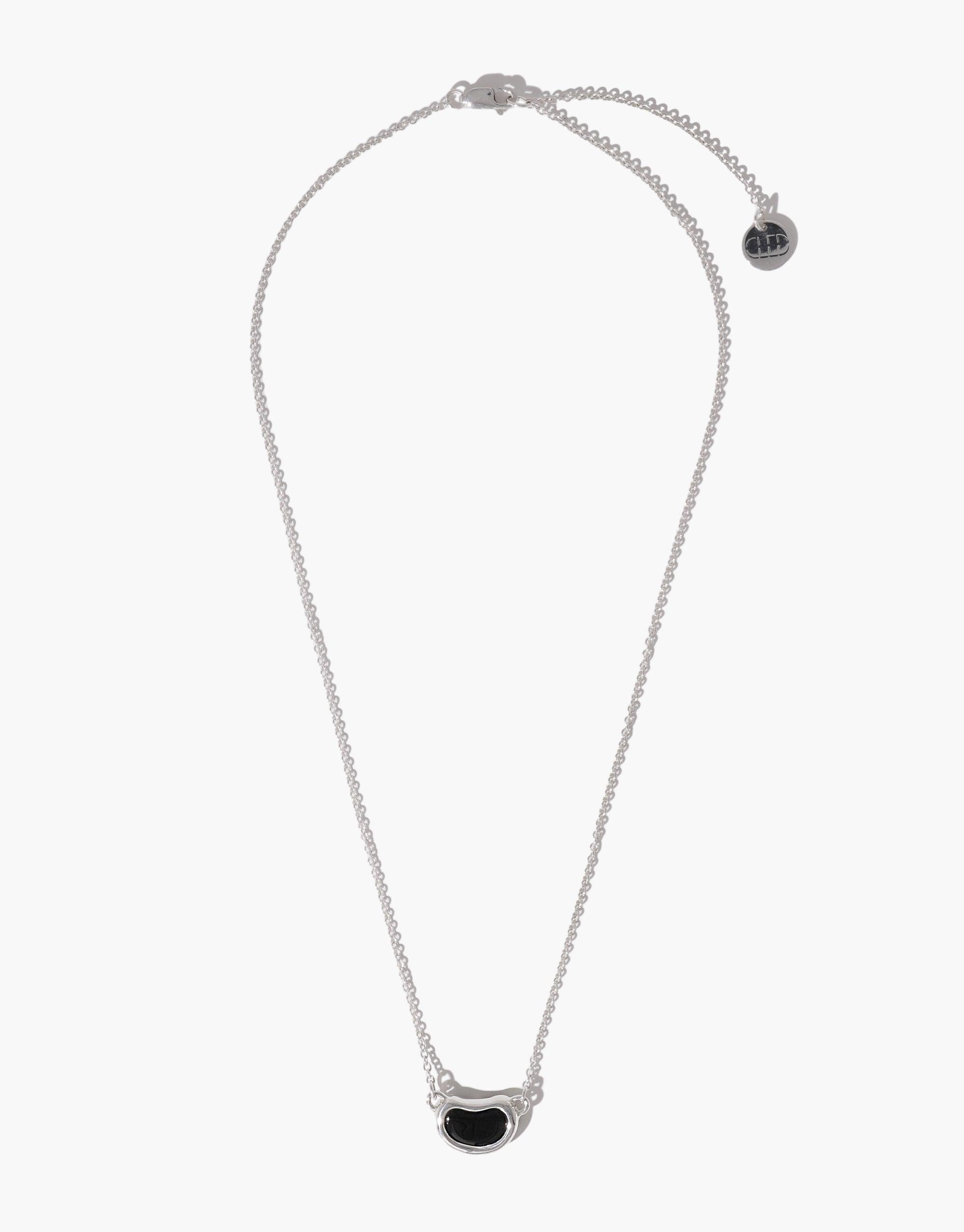 Elegant silver necklace featuring a delicate chain with a unique bean-shaped pendant in black, inspired by nature's organic forms. The Bean Necklace showcases a minimalist design perfect for everyday wear, embodying growth and transformation. CLED