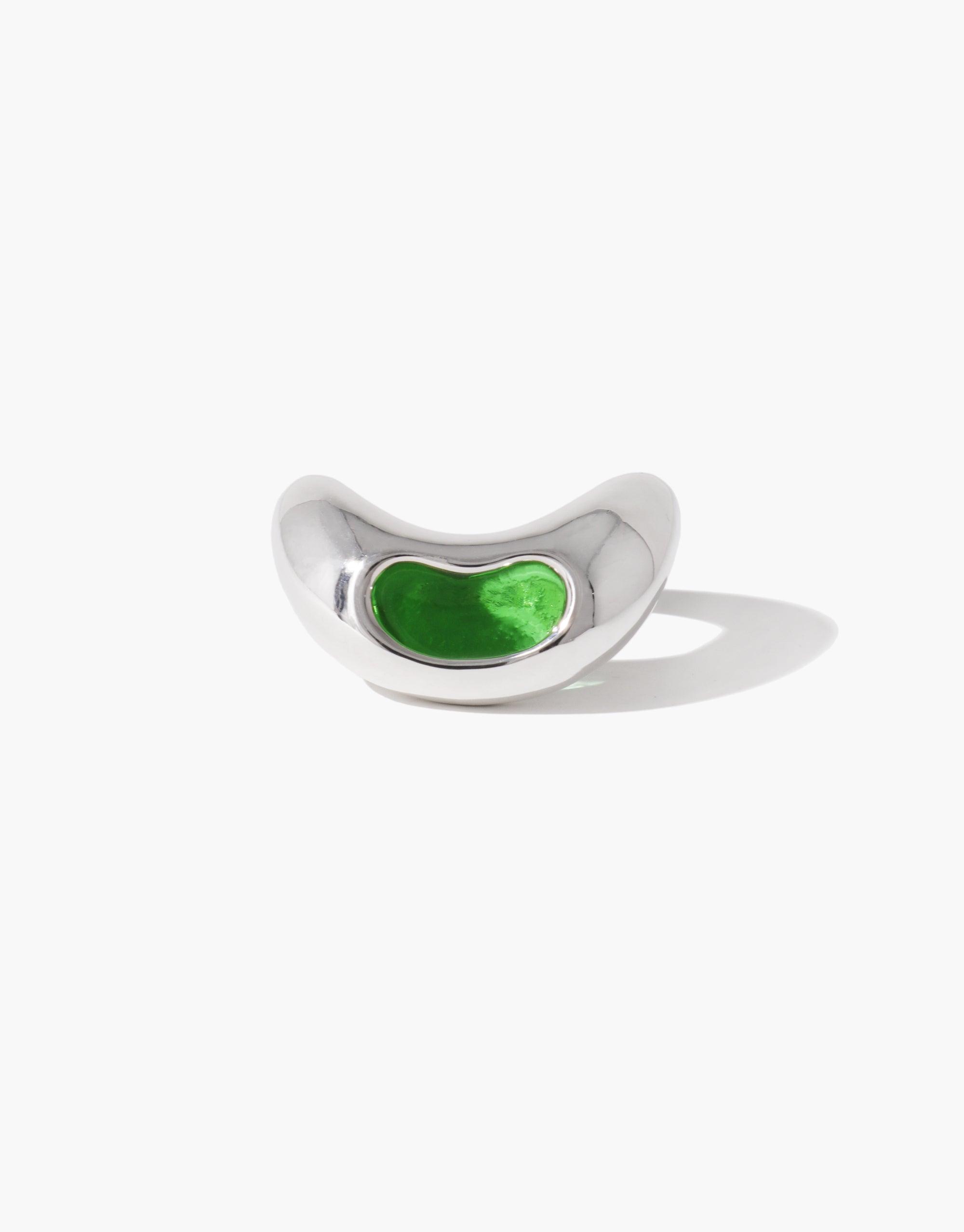 Sleek silver Bean Ring featuring a vibrant green inlay, inspired by nature's organic shapes. Unique jewelry piece showcasing a smooth, curved design reminiscent of a legume pod. Elegant and modern accessory that captures the essence of natural growth and transformation. CLED