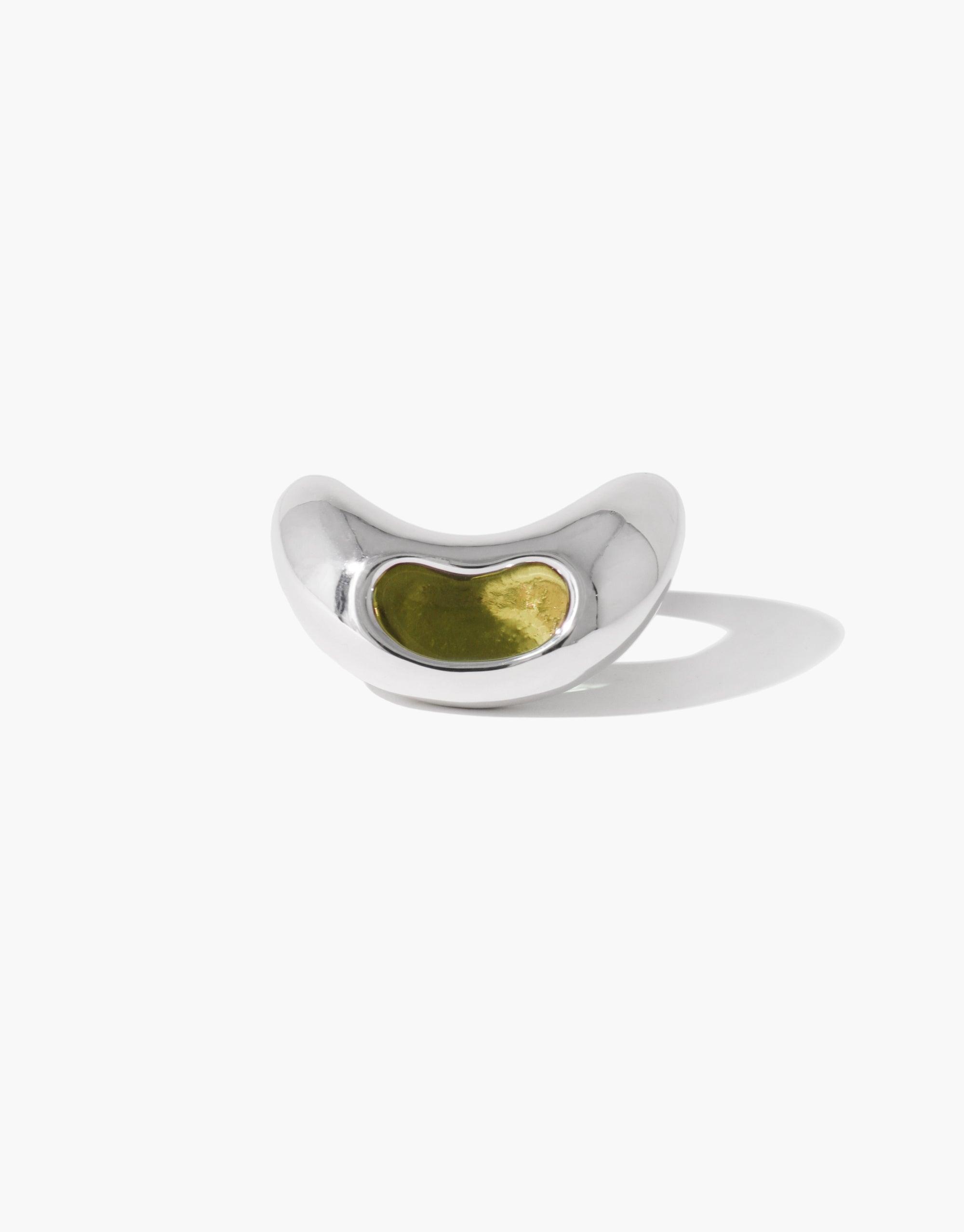 Elegant silver Bean Ring featuring a curved design with a green inlay, inspired by nature's organic shapes and legume patterns. Unique jewelry piece capturing growth and transformation. CLED Bean Ring