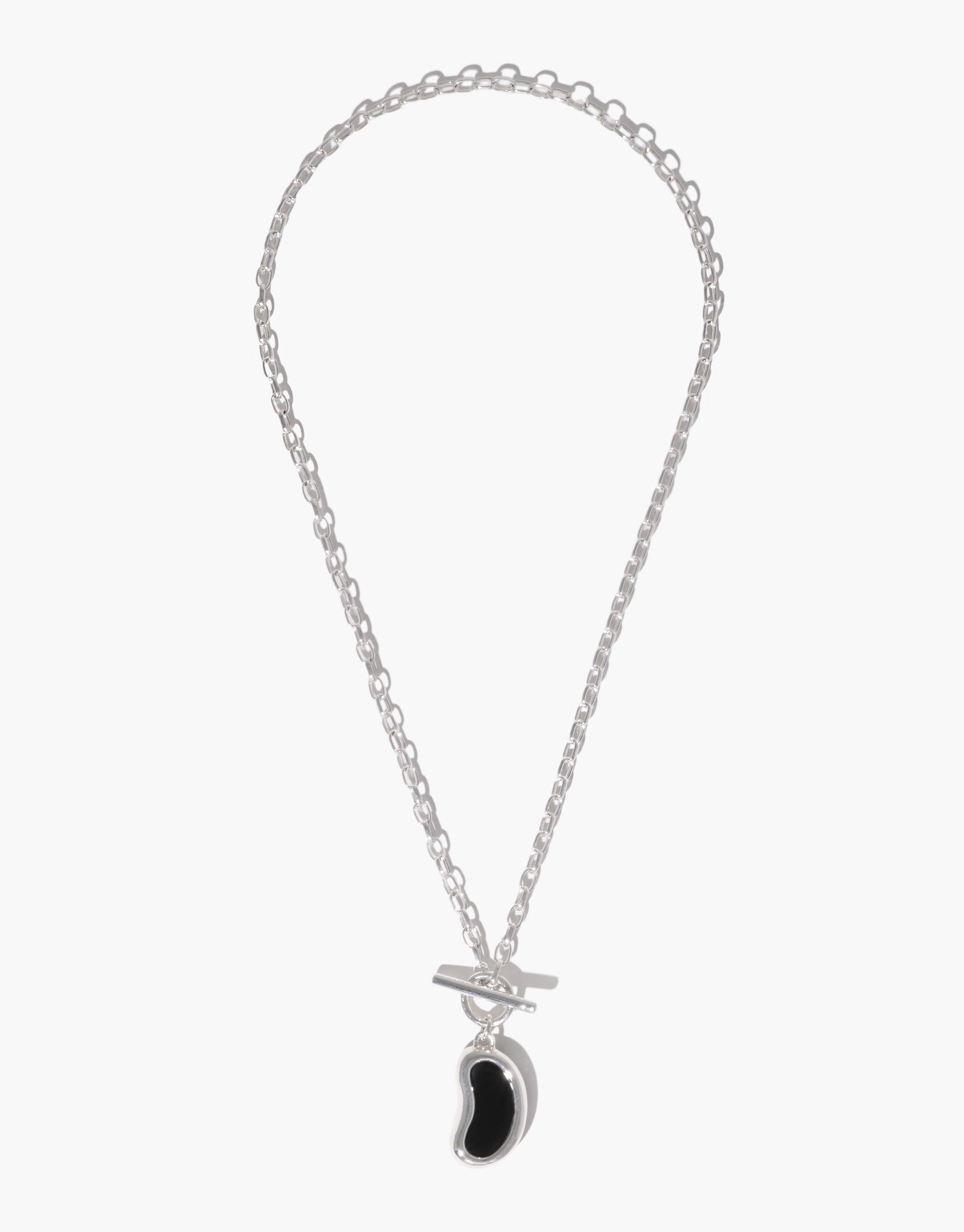 Silver chain necklace with a unique bean-shaped pendant, showcasing a sleek and modern design inspired by nature's organic forms. The Bean Toggle Necklace combines elegance with simplicity, perfect for everyday wear or special occasions. CLED