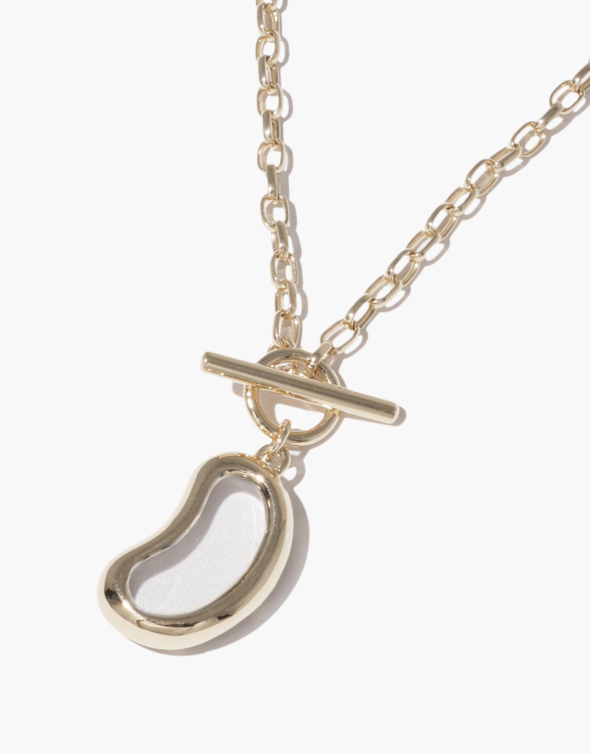 Elegant gold-toned Bean Toggle Necklace featuring a smooth, curved legume-inspired pendant on a delicate chain, showcasing nature's organic beauty and growth. Perfect for everyday wear or special occasions. Bean Toggle Necklace by CLED.