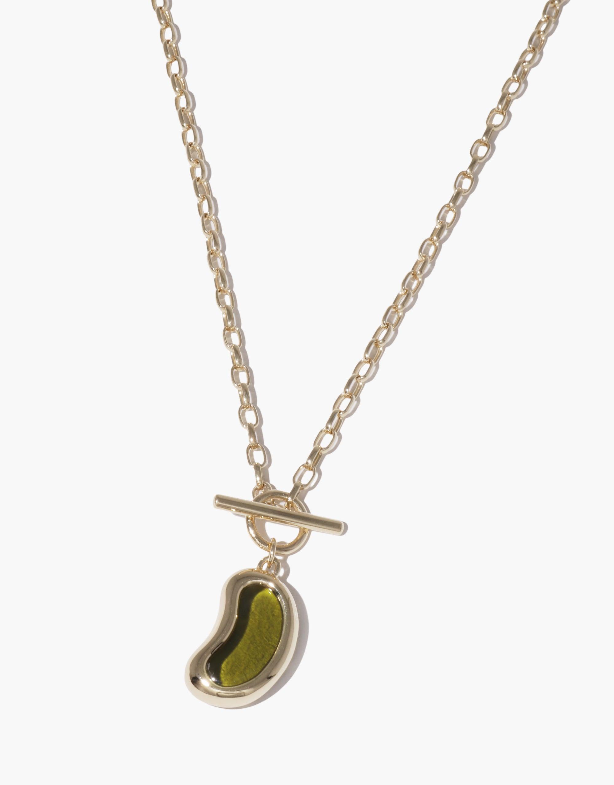 Elegant gold-tone chain necklace featuring a unique bean-shaped toggle pendant in green, inspired by nature's organic forms. Stylish and versatile Bean Toggle Necklace, perfect for everyday wear or special occasions. CLED