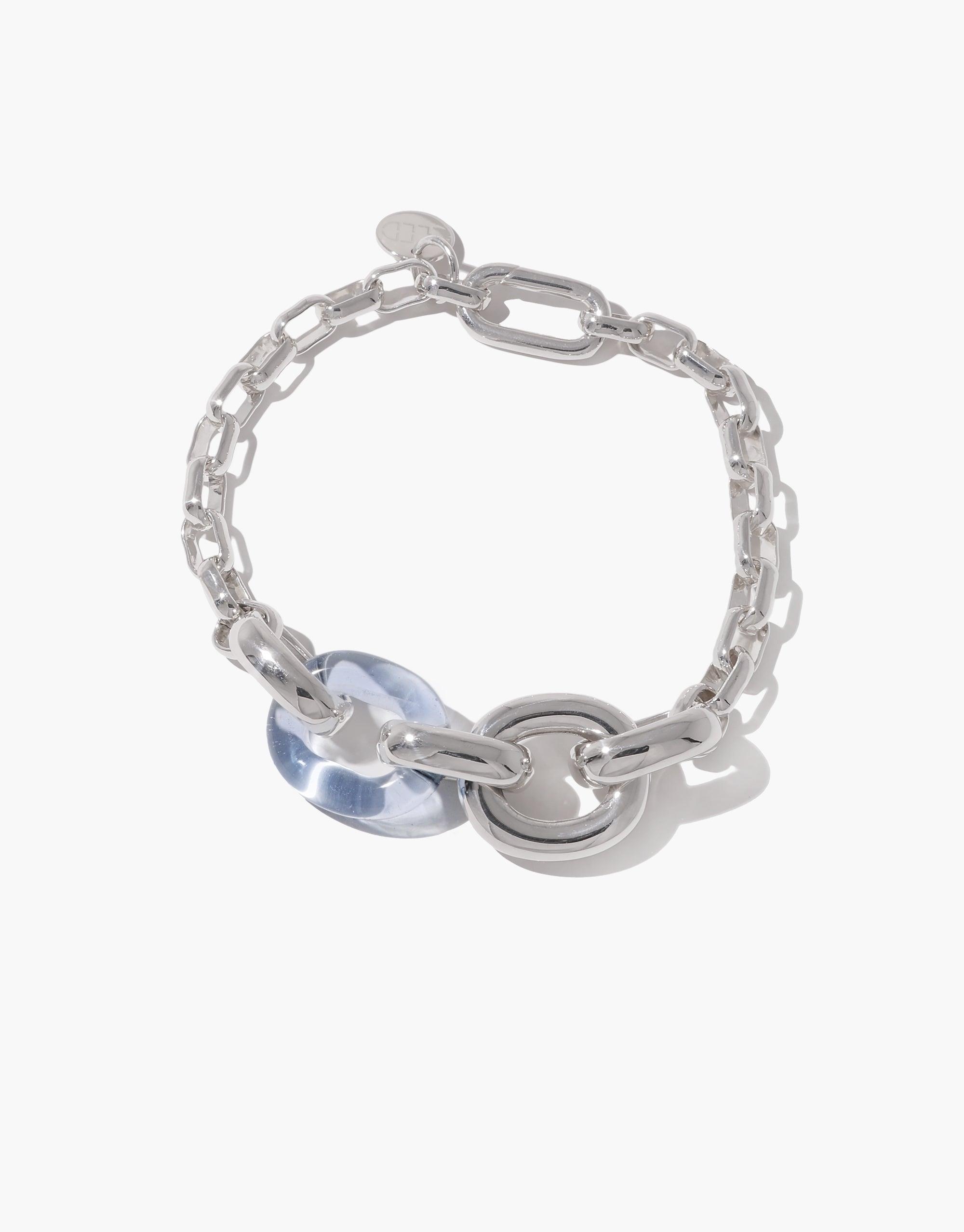 Stylish Loop Chain Bracelet featuring silver-toned metal links and a unique blue glass accent, showcasing upcycled materials in a modern design. Symbolizes unity and sustainability in jewelry craftsmanship. Loop Chain Bracelet by CLED.