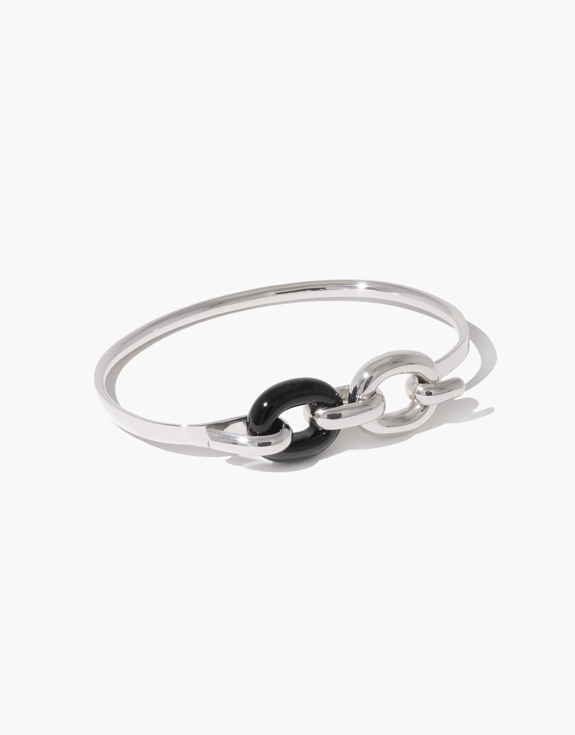 Sleek silver bangle bracelet with interlocking circular design featuring a black accent, symbolizing unity and connection. Elegant and minimalist Loop Hook Bracelet from the upcycled In The Loop collection. CLED