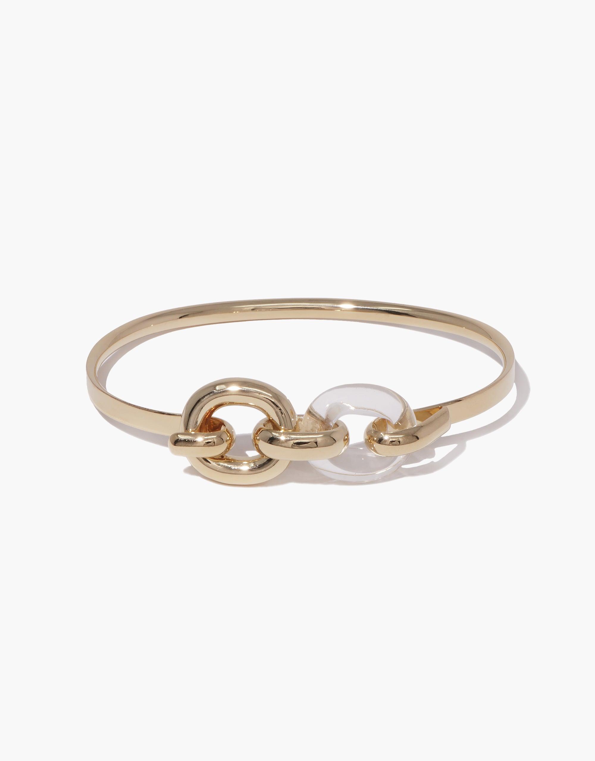 Elegant gold-toned Loop Hook Bracelet featuring interconnected circular links, including a clear glass or acrylic element, symbolizing unity and upcycling. Sleek design with a mix of materials, perfect for everyday wear. Part of the In The Loop collection by CLED.