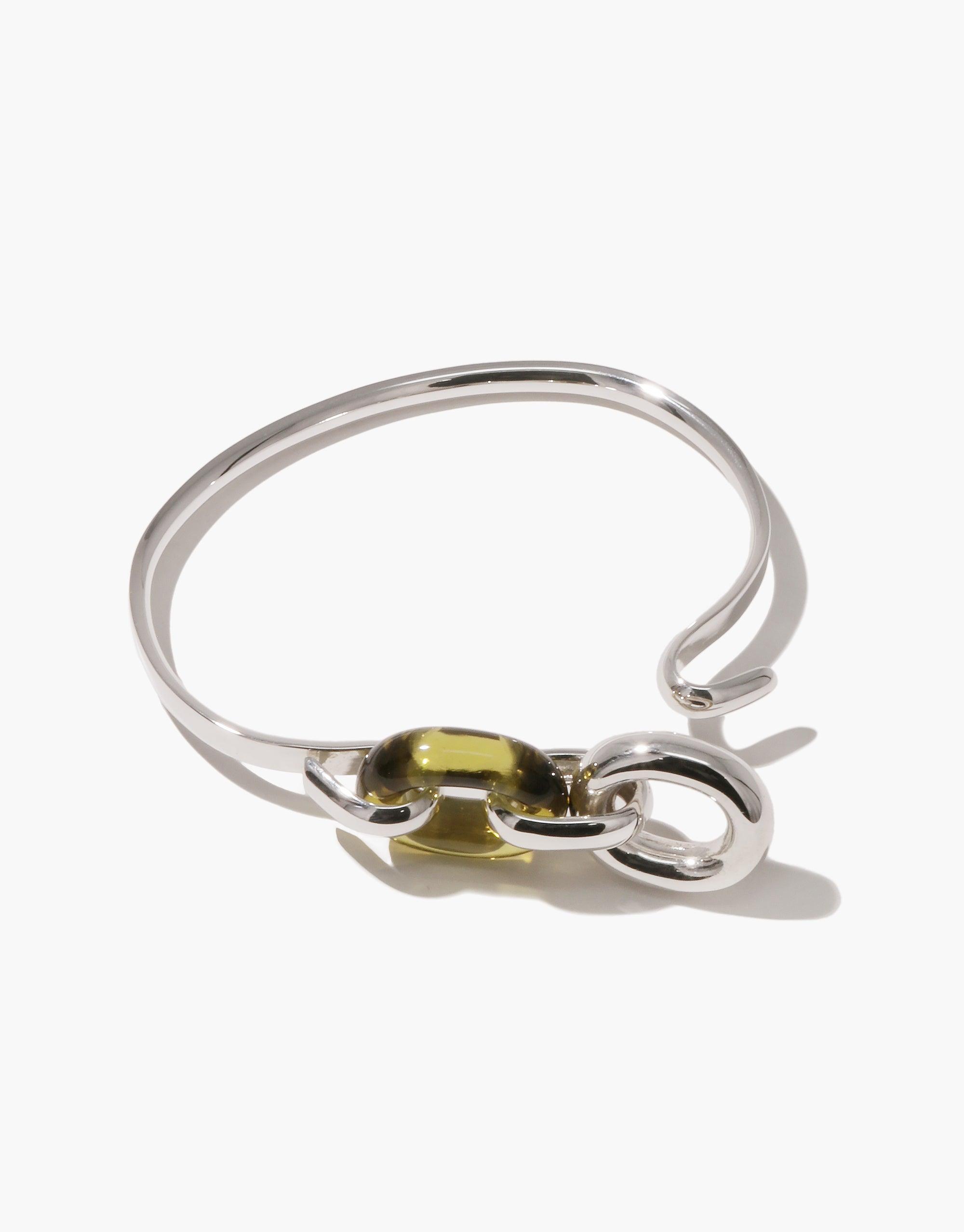 Elegant silver Loop Hook Bracelet with unique green glass accent, showcasing sustainable design and interconnectedness. Sleek and modern, this upcycled jewelry piece embodies unity and creativity. Loop Hook Bracelet by CLED.