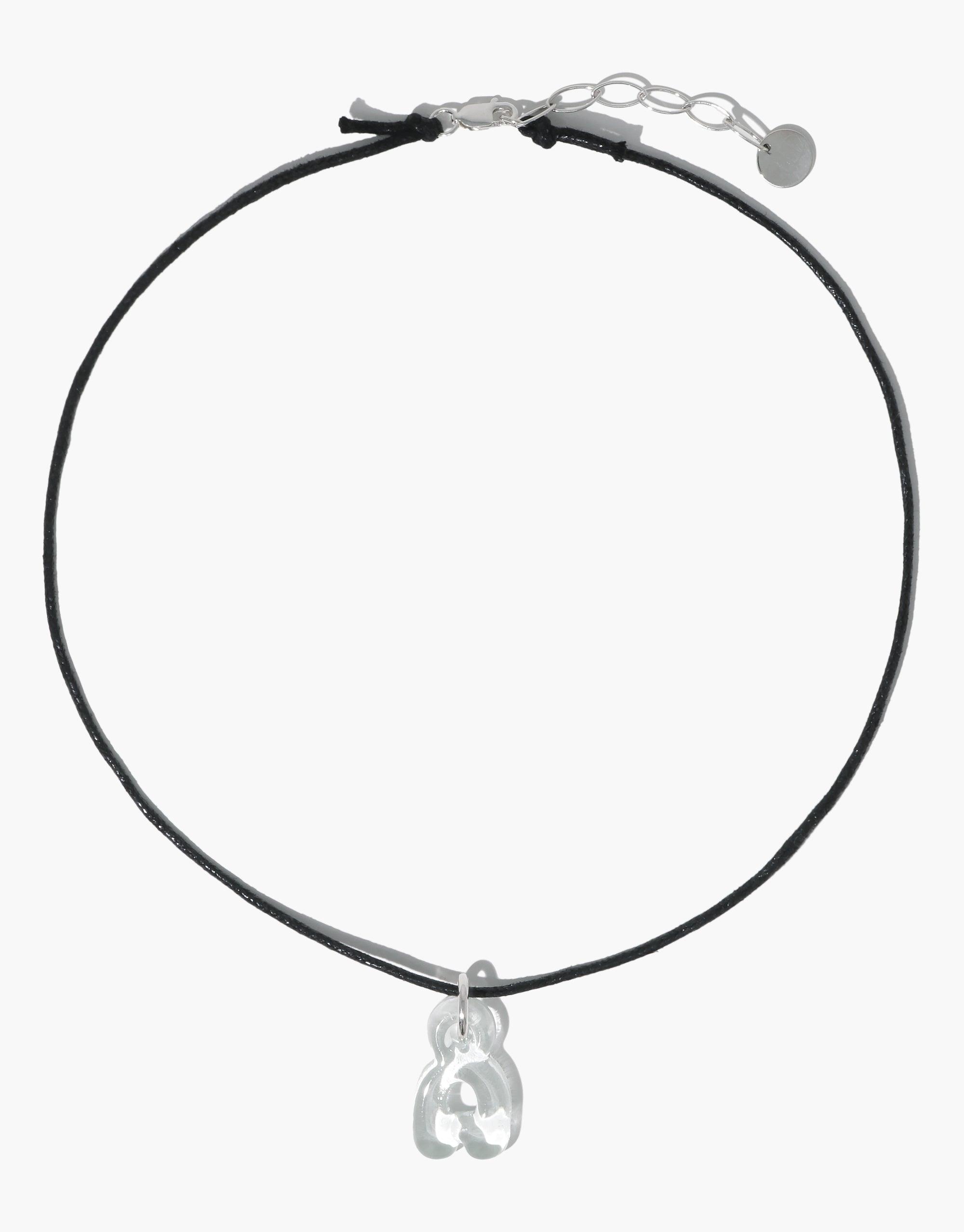 Sleek black cord necklace with adjustable silver clasp and transparent bubble letter 'a' charm pendant, showcasing eco-friendly design and personalized style. Letter Charm | Alphabet by CLED