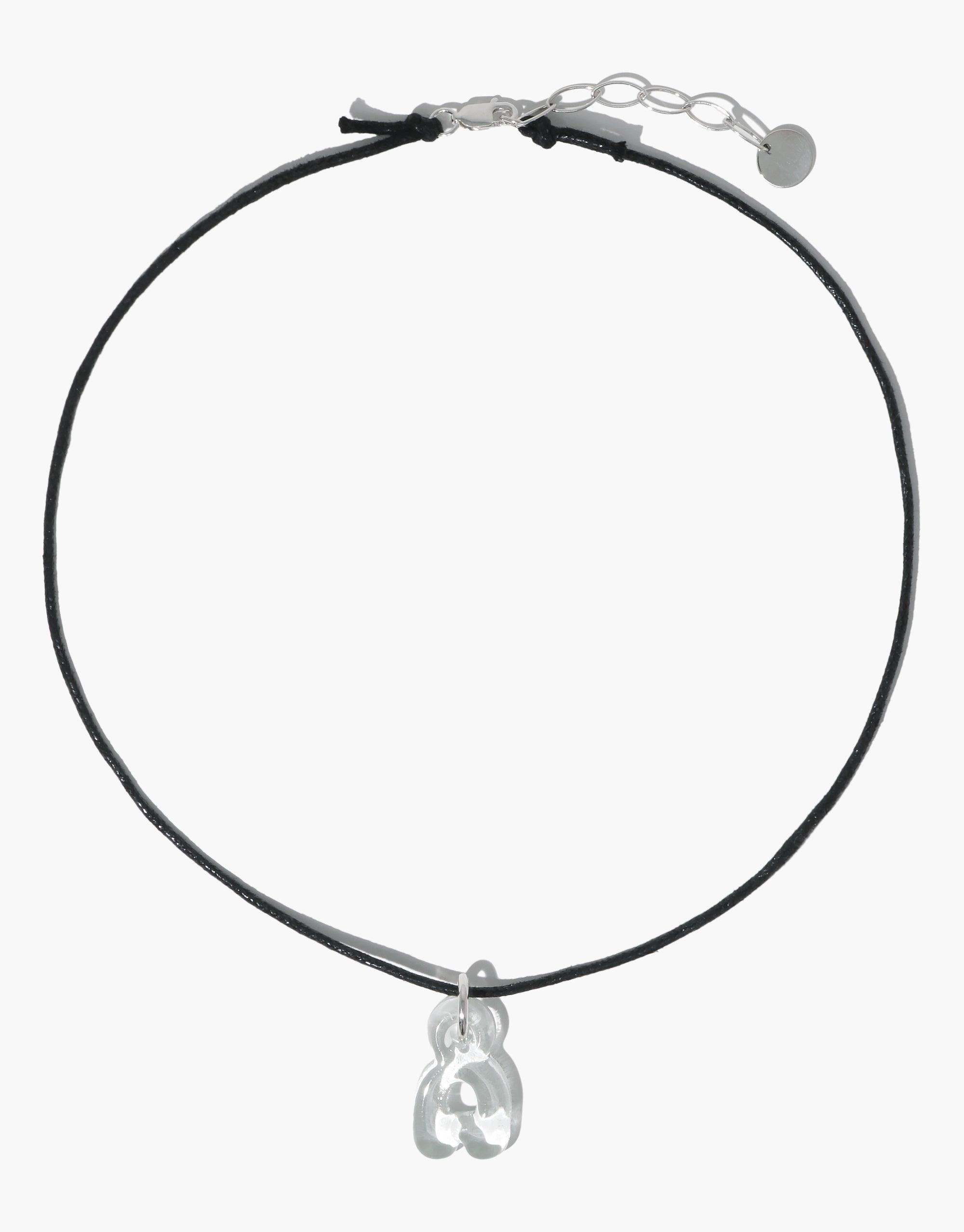 Adjustable black cord necklace with silver clasp and charm holder, ideal for attaching letter, number, or icon charms. Versatile 16-18 inch length. Sustainable cotton cord with plant-based finish. Cord Necklace by CLED.