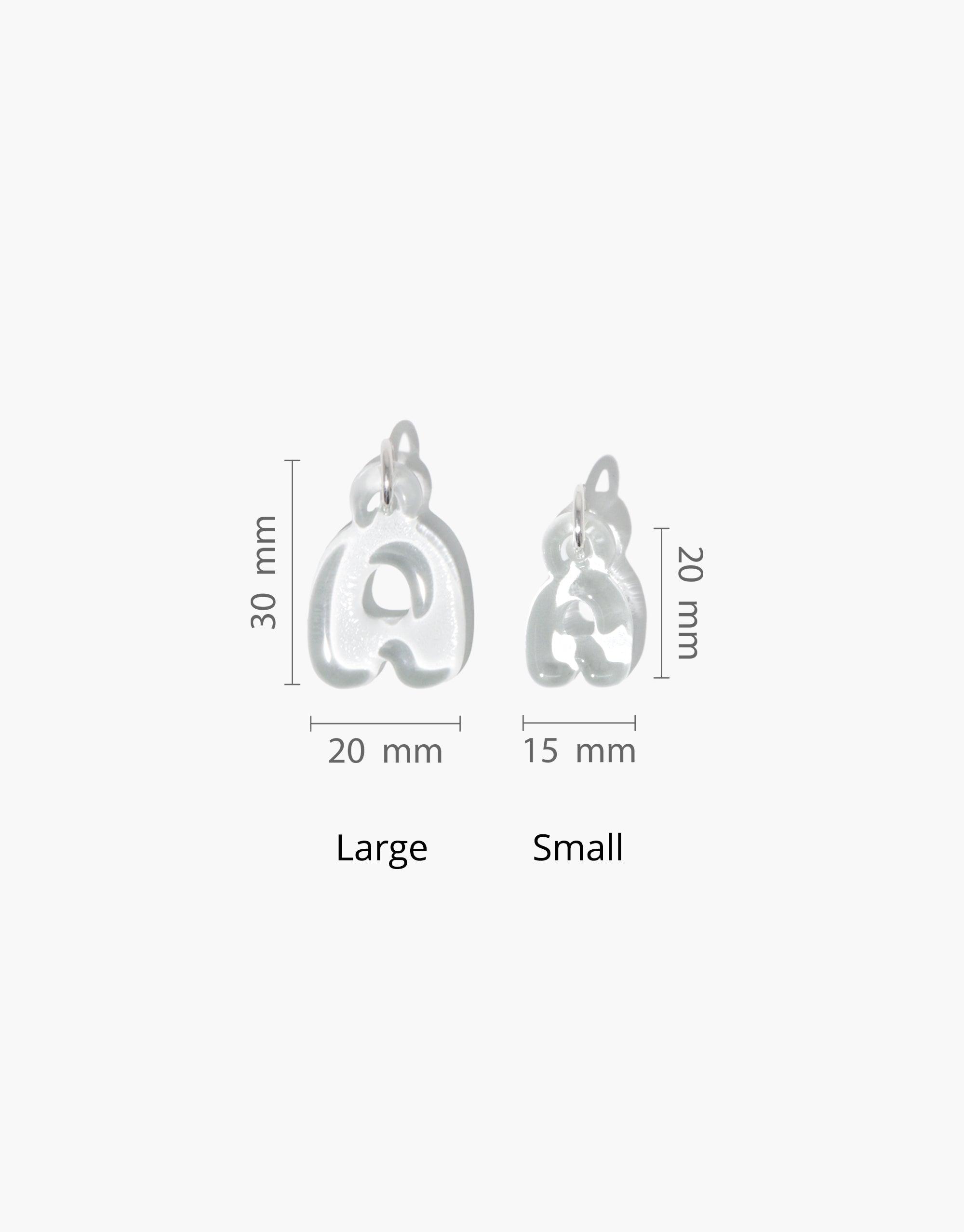 Letter Charm | Alphabet size comparison showing large and small bubble letter 'a' charms with dimensions. Large charm measures 30mm x 20mm, small charm 20mm x 15mm. Eco-friendly, playful design made from recycled window glass. CLED