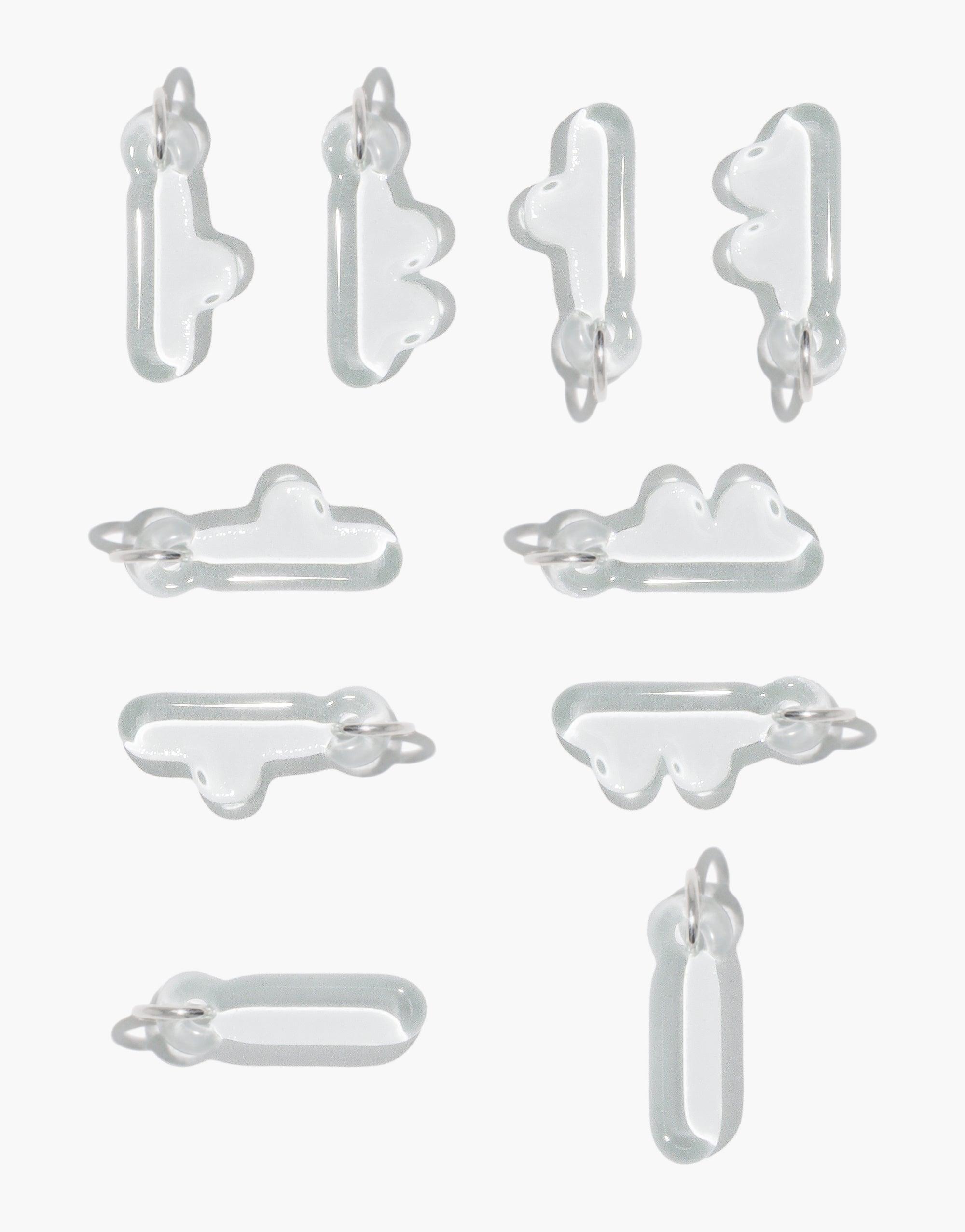 Various transparent glass letter charms in bubble-like shapes, featuring Korean Hangul and English alphabet designs. Eco-friendly jewelry pieces for personal expression and cultural celebration. Letter Charm | 한글 Hangul by CLED