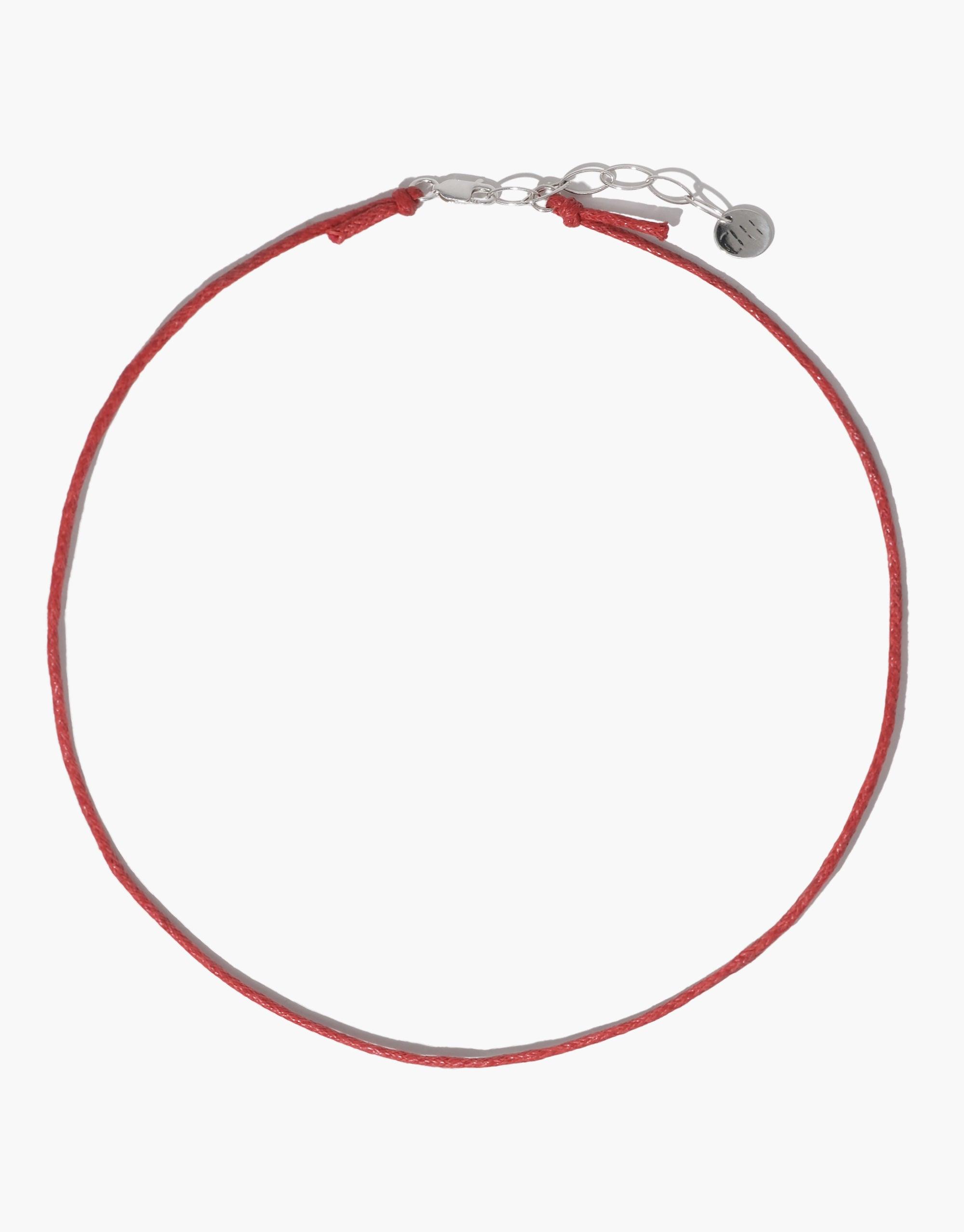 Adjustable red cotton cord necklace with silver clasp and extender chain, ideal for attaching charms. Versatile 16-18 inch length. Minimalist design perfect for layering or wearing solo. Sustainably crafted accessory. Cord Necklace by CLED.
