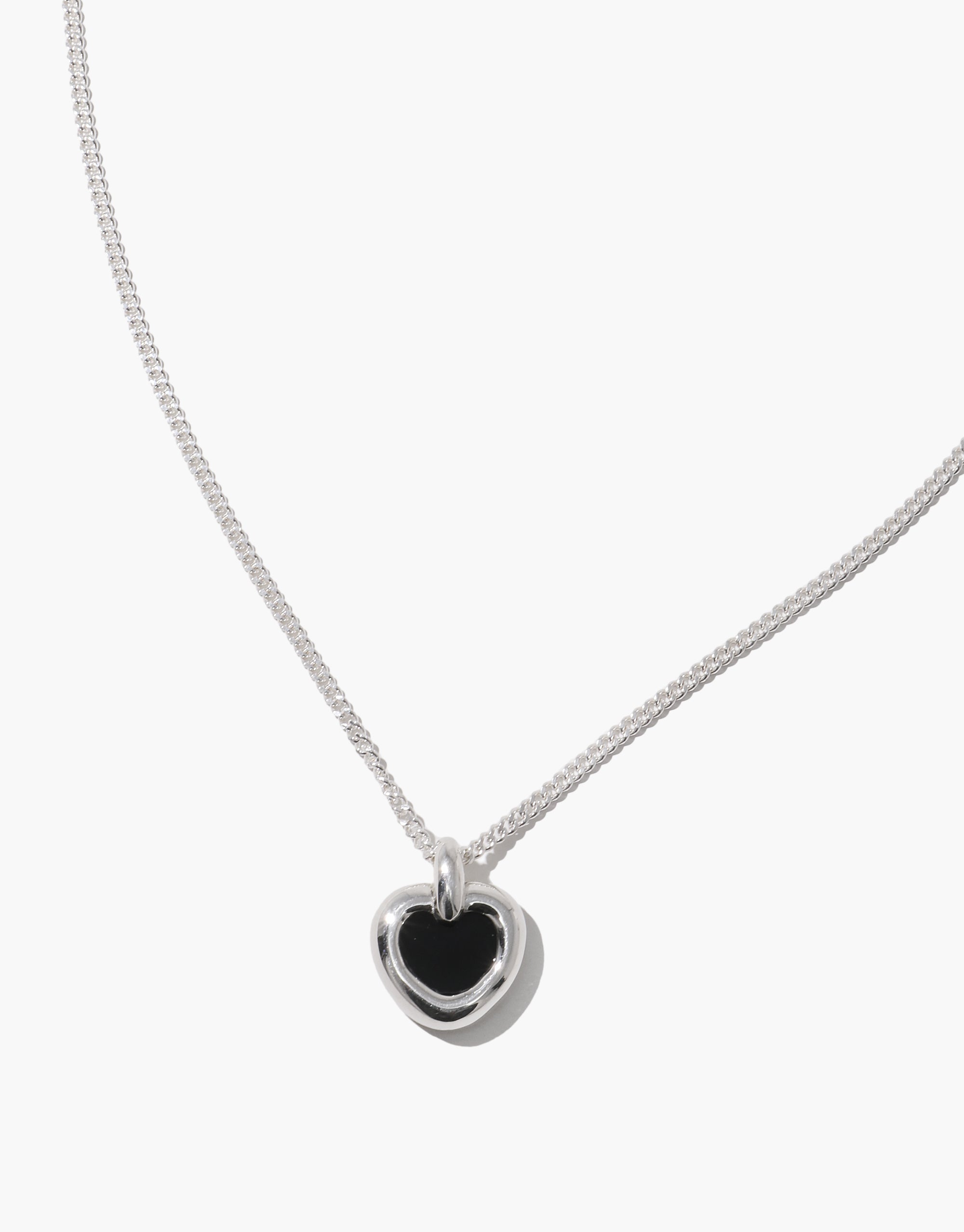 Core Heart Necklace | Small features a silver chain with a lightweight, softly rounded black heart pendant, embodying CLED's eco-conscious design by transforming discarded glass into elegant jewelry.