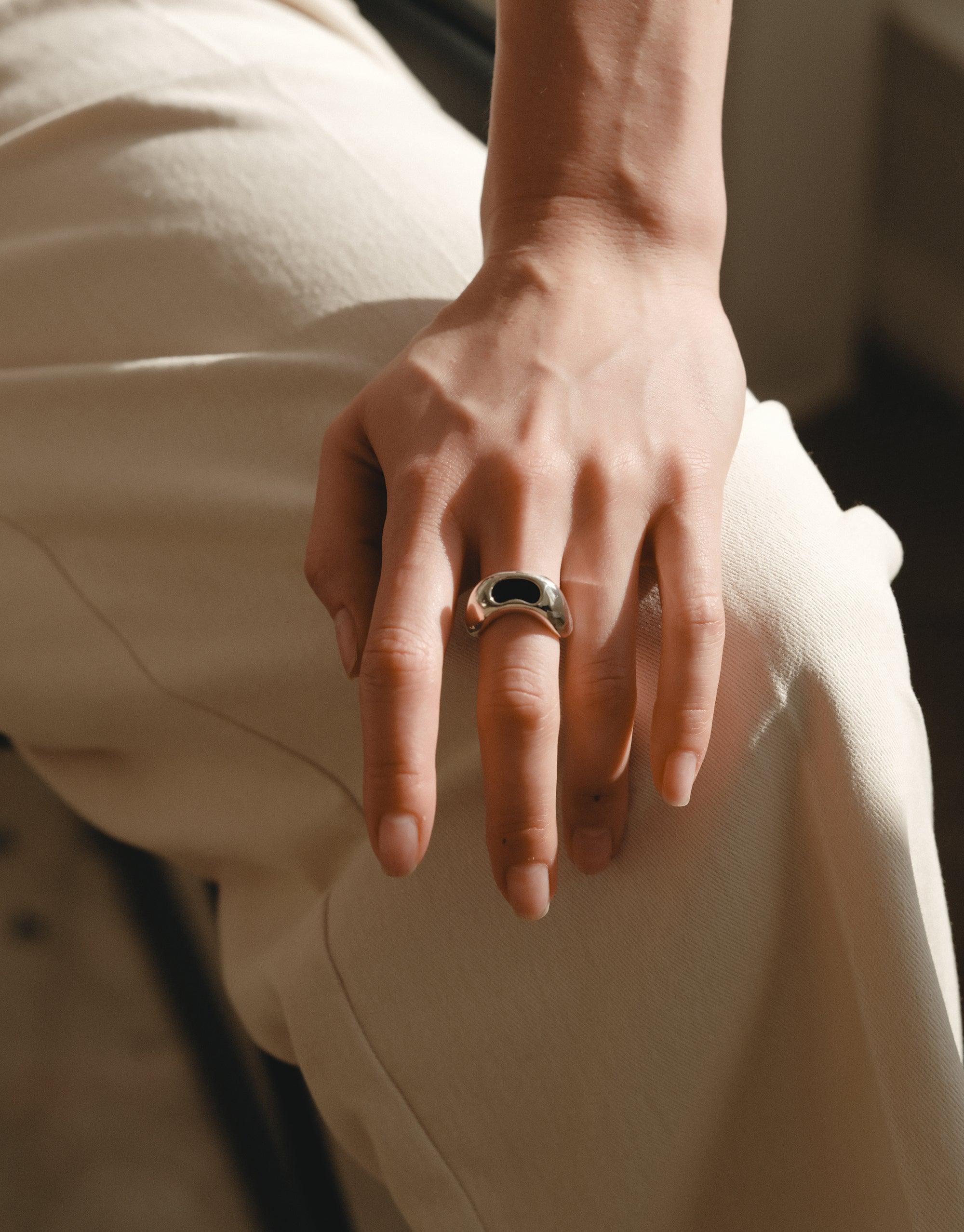 Bean Ring on hand showcasing organic shape inspired by legume plant, reflecting natural beauty and growth. Elegant design captures essence of nature's creativity, perfect for nature lovers. CLED Bean Ring.
