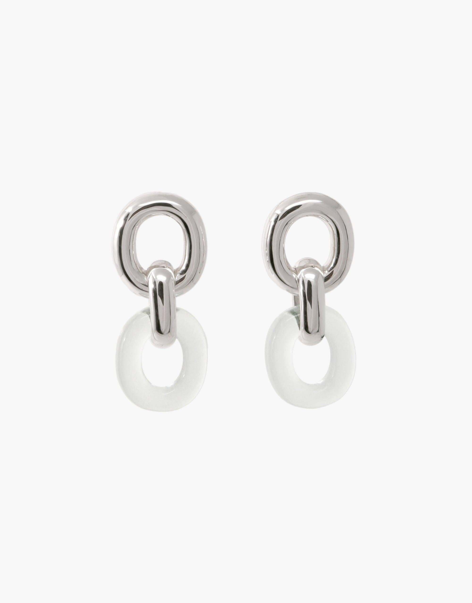 Elegant Connected Loop Earrings featuring silver-toned metal and white circular elements, symbolizing unity and connection. Upcycled design showcases sustainable fashion and timeless style. Perfect for everyday wear or special occasions. Connected Loop Earrings by CLED.