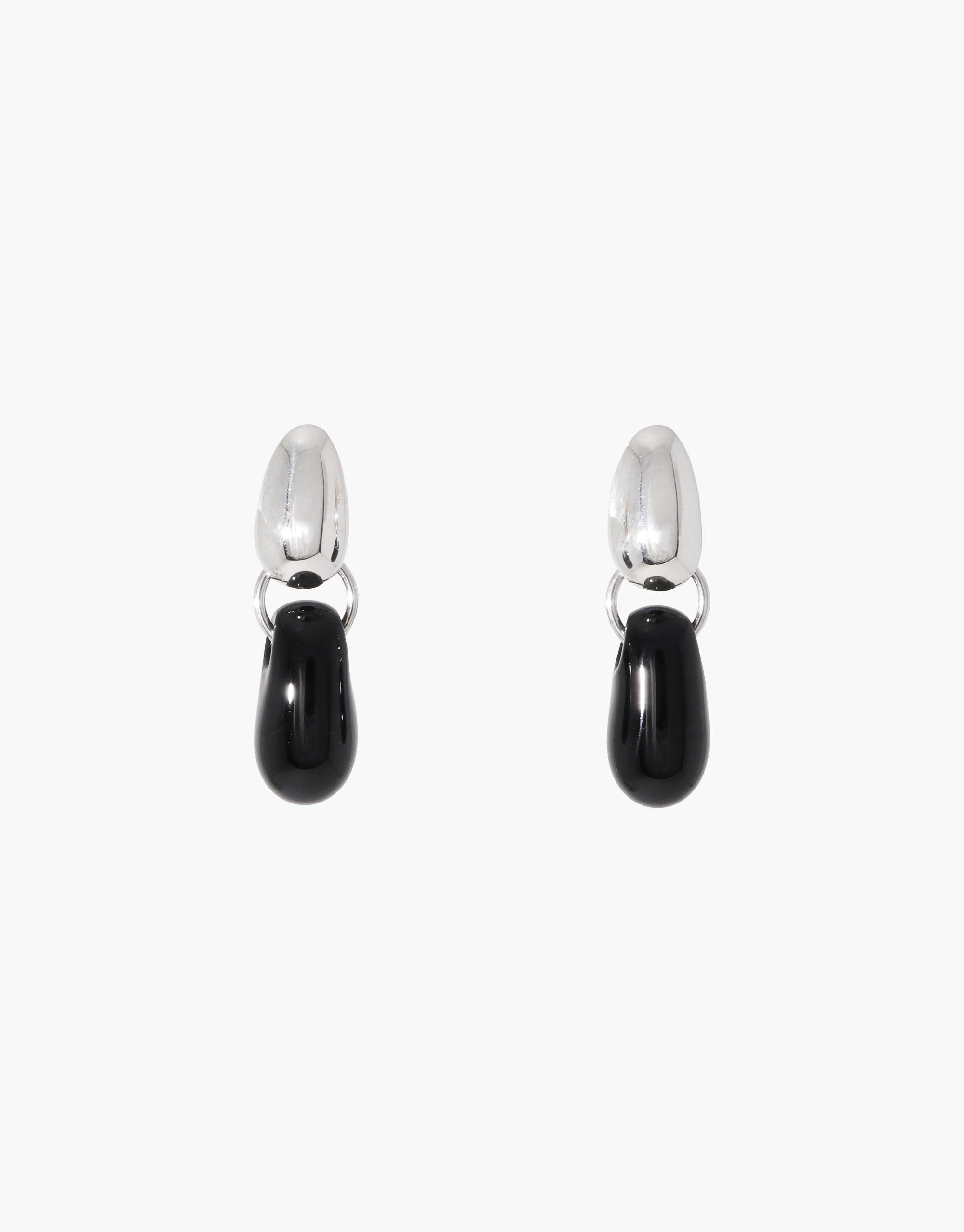 Elegant Drop Counts Earrings featuring silver oval posts with sleek black teardrop-shaped pendants, inspired by water and eco-consciousness. Handcrafted from upcycled glass bottles, these minimal earrings embody sustainable luxury. Perfect for those who appreciate eco-friendly fashion and timeless design. CLED Drop Counts Earrings.