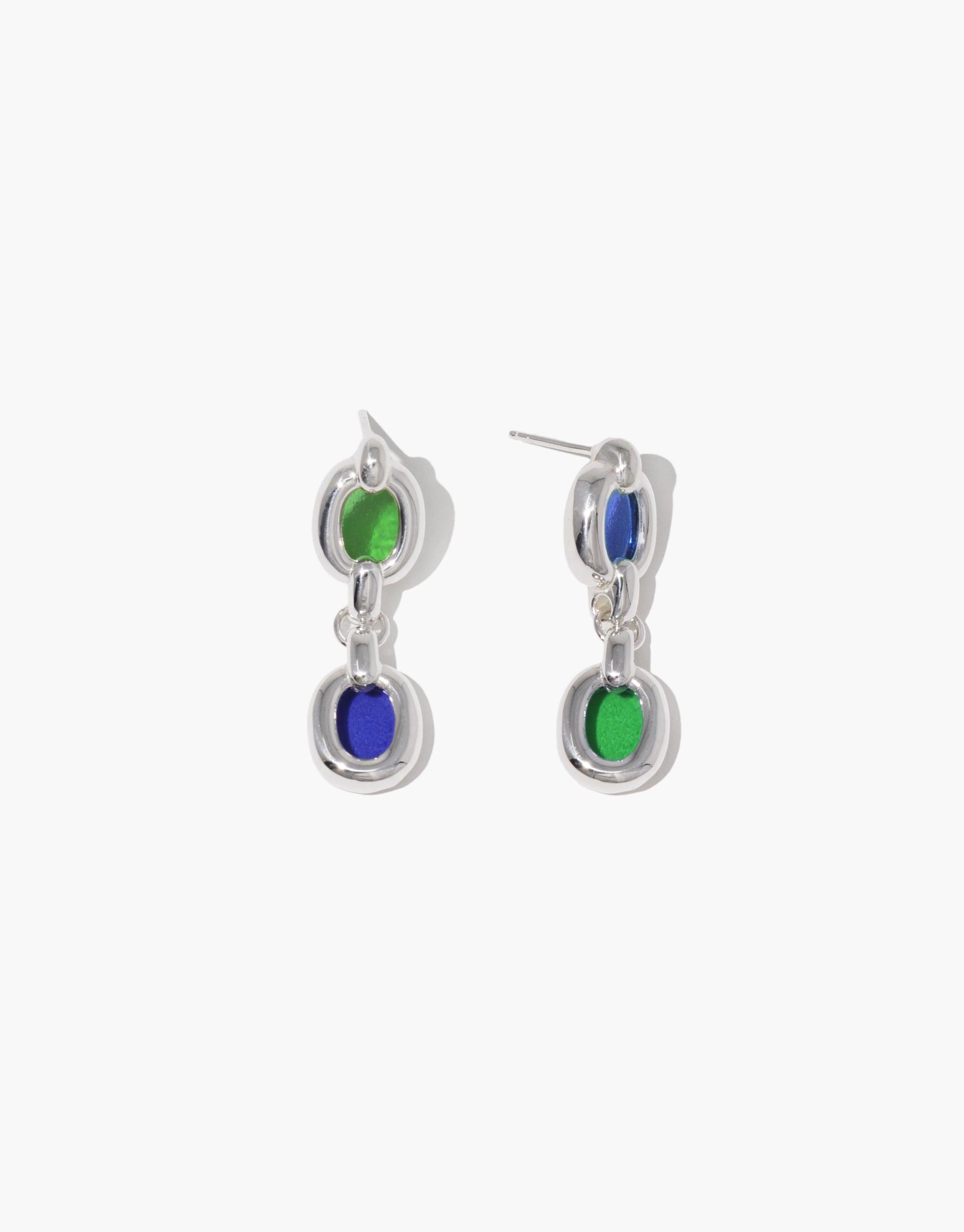 Elegant Duo Core Loop Earrings featuring silver-toned metal with vibrant green and blue circular elements. Each earring showcases two interconnected loops, symbolizing unity and upcycling. Perfect for sustainable fashion enthusiasts. Handcrafted by CLED, Duo Core Loop Earrings.