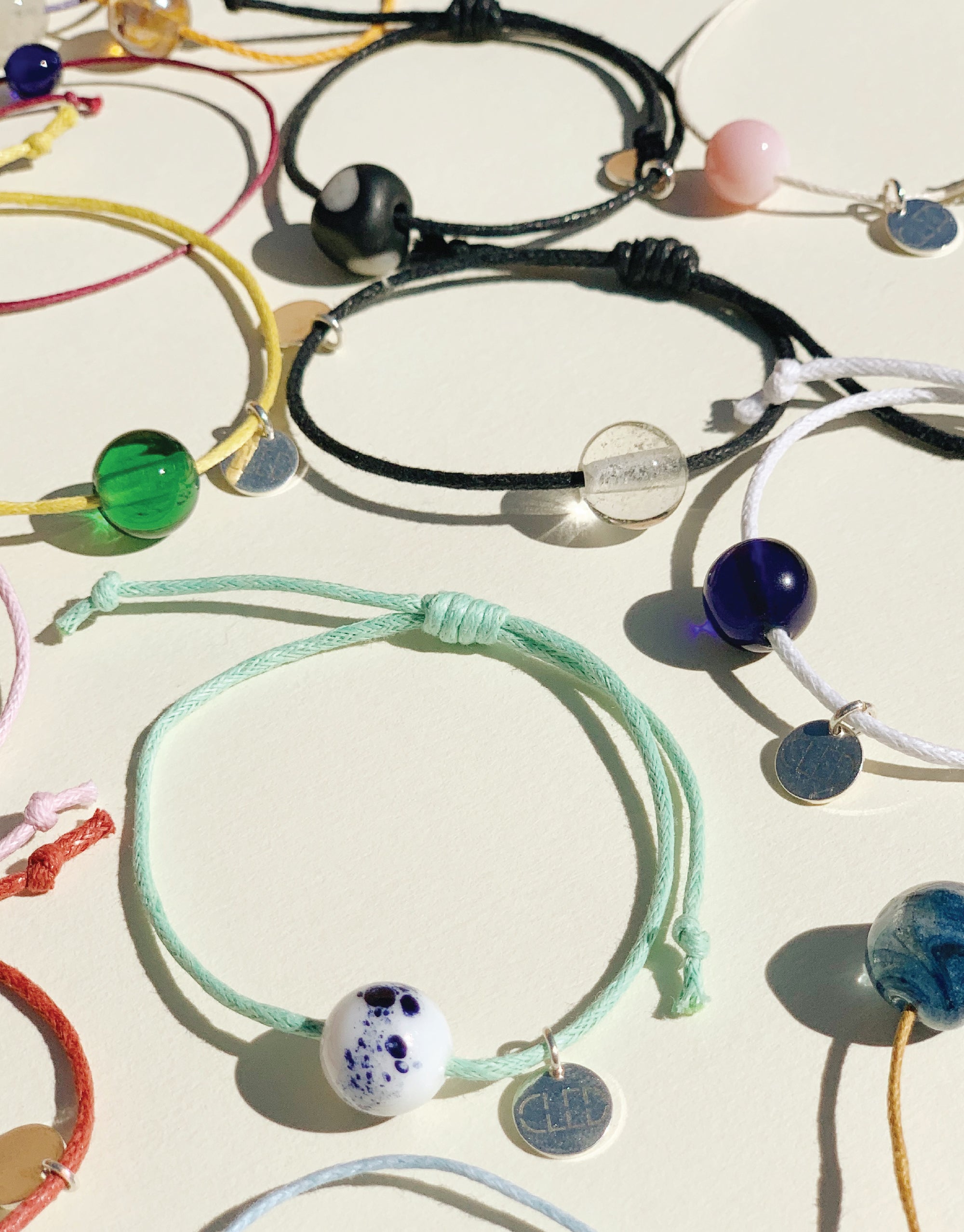 A collection of vibrant bracelets adorned with various charms, showcasing a delightful array of colors and designs.