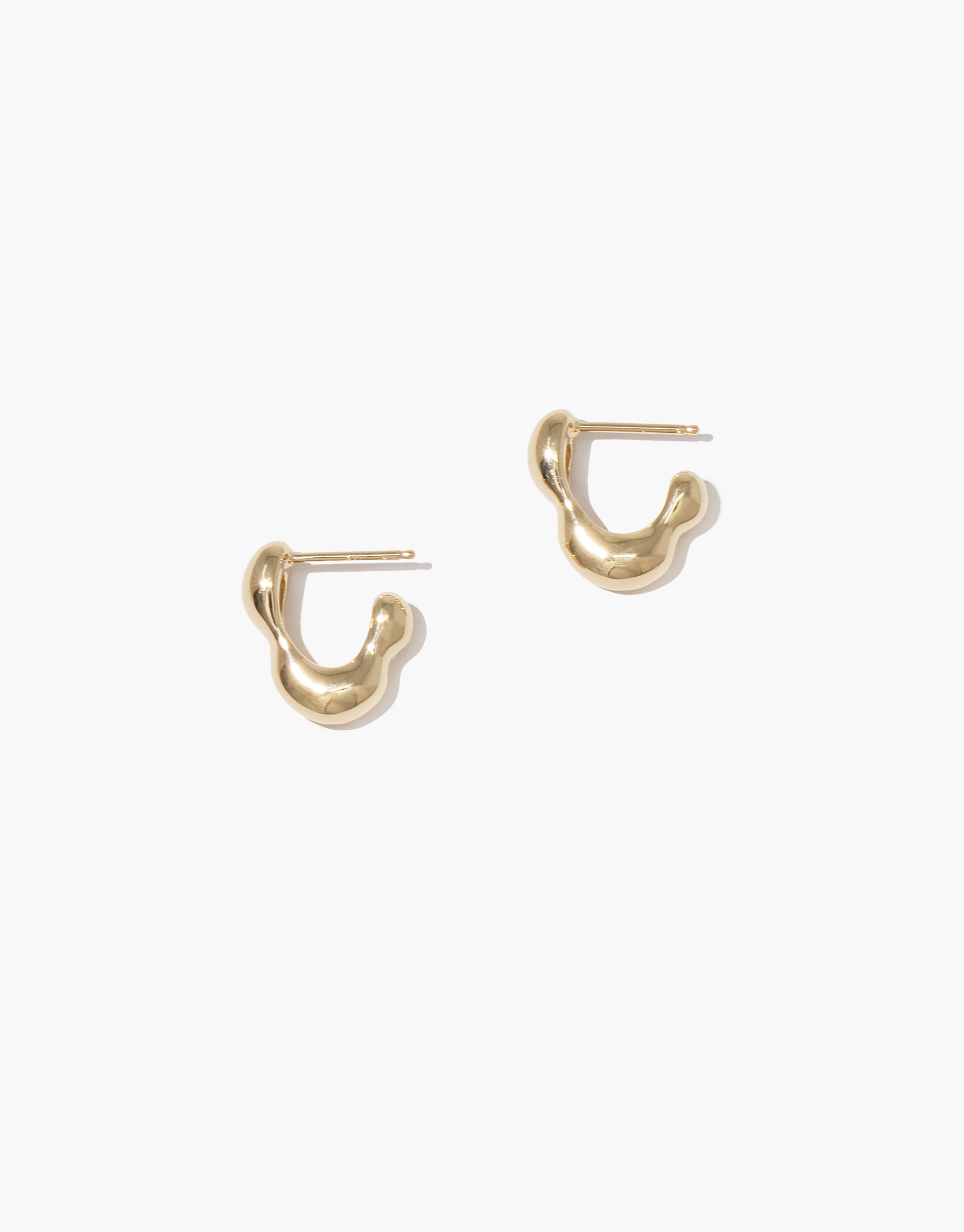 Flow Hoop Earrings: Sculptural gold-tone hoops with organic, wave-like curves from the Goyo Collection by CLED