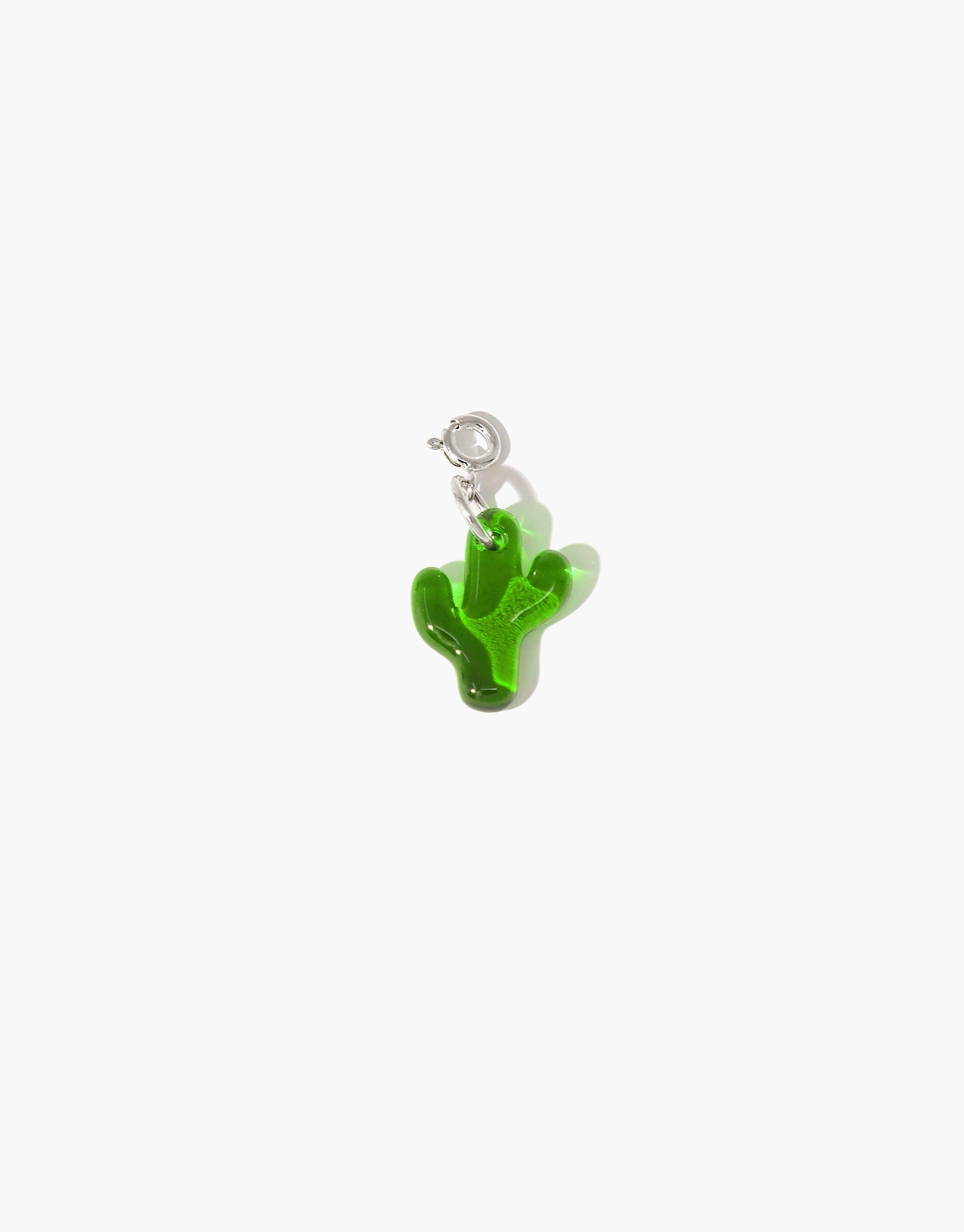 Green glass cactus-shaped charm with silver clasp, upcycled from discarded bottles. Handmade eco-friendly jewelry accessory for necklaces or bracelets. Cactus Icon Charm by CLED.