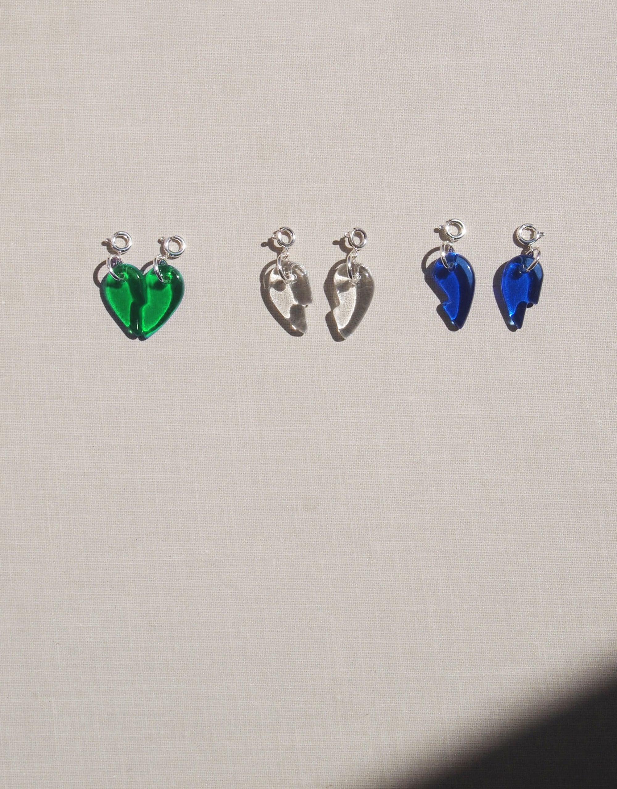 Split Heart Icon Charm featuring a sterling silver broken heart design, symbolizing unity. Handmade using upcycled glass, each charm is unique. Sold individually, chain not included.