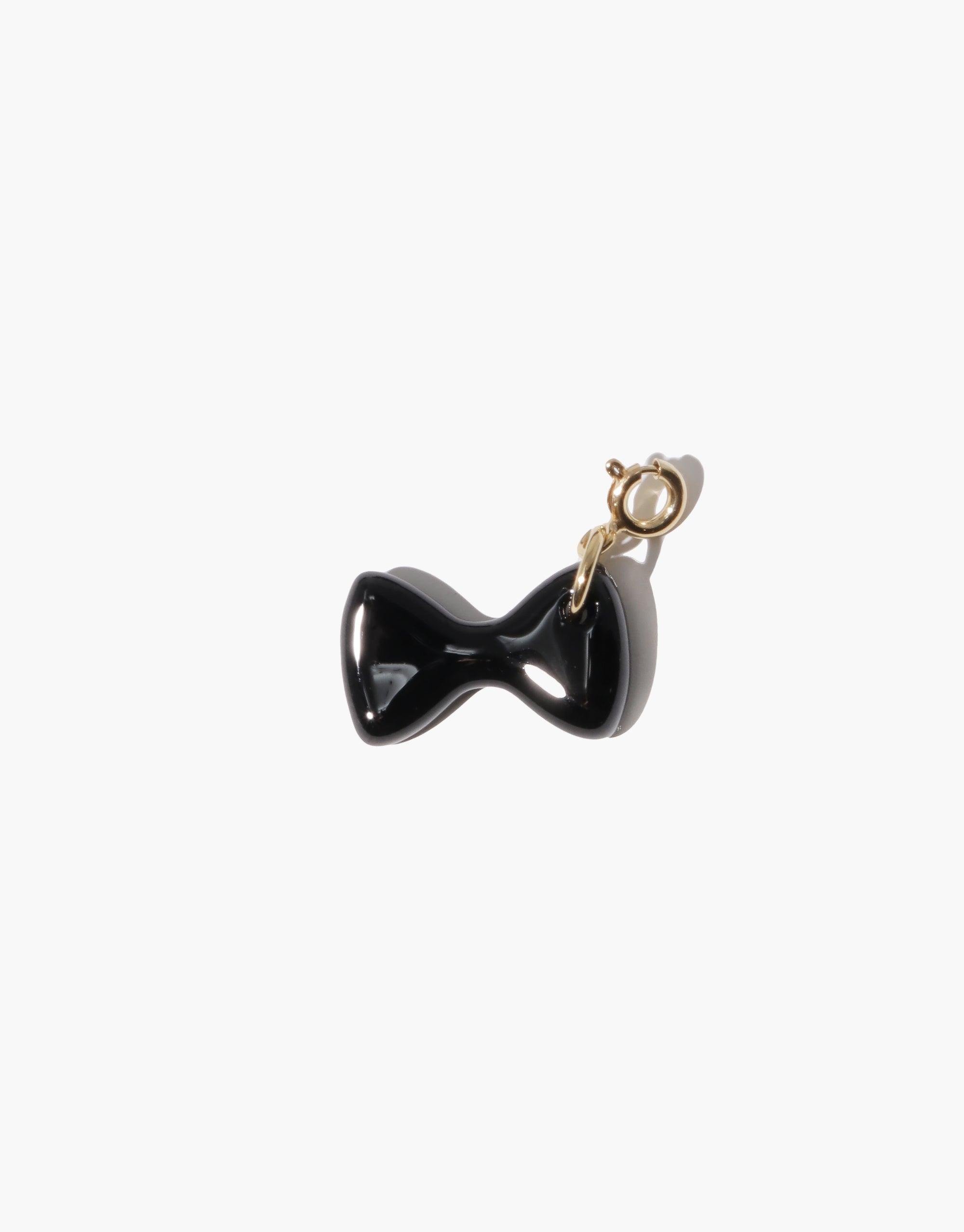 Elegant black bow-shaped charm with gold clasp for jewelry customization. Stylish accessory to enhance necklaces or bracelets. Bow C Icon Charm by CLED