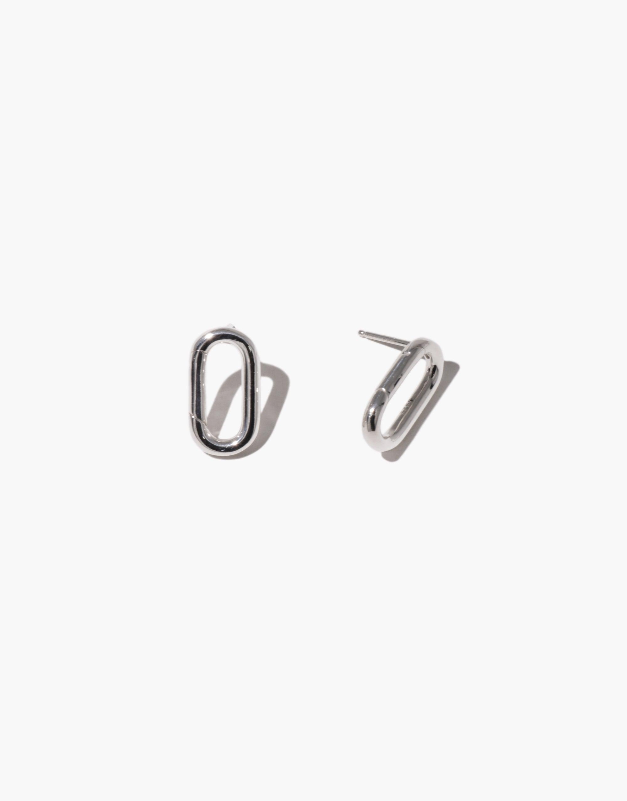 Sleek silver Loop Stud Earrings with oval-shaped design, perfect for attaching charms. Versatile and minimalist jewelry piece for customizable style. Loop Stud Earring by CLED.