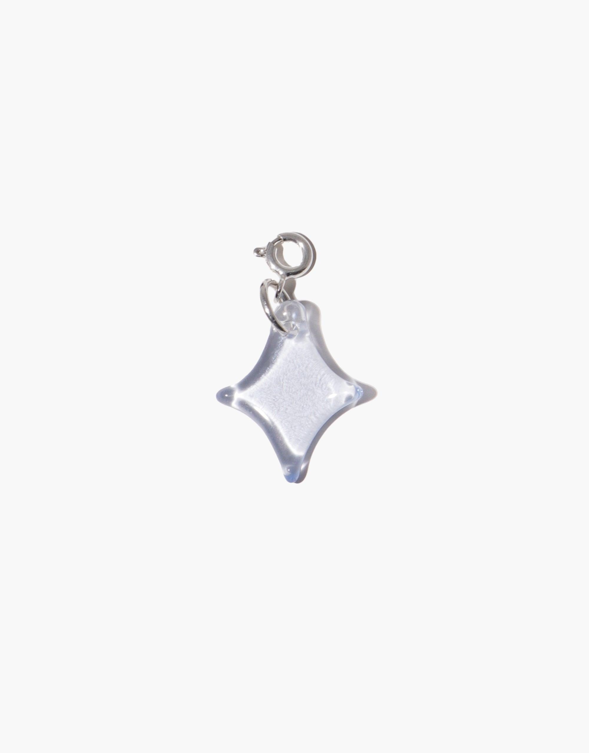Sparkle A Icon Charm: Elegant four-pointed star-shaped charm in translucent material with silver attachment loop. Ideal accessory for necklaces or bracelets, adding a playful and distinctive touch to any jewelry ensemble. Perfect for personalization and style enhancement. CLED