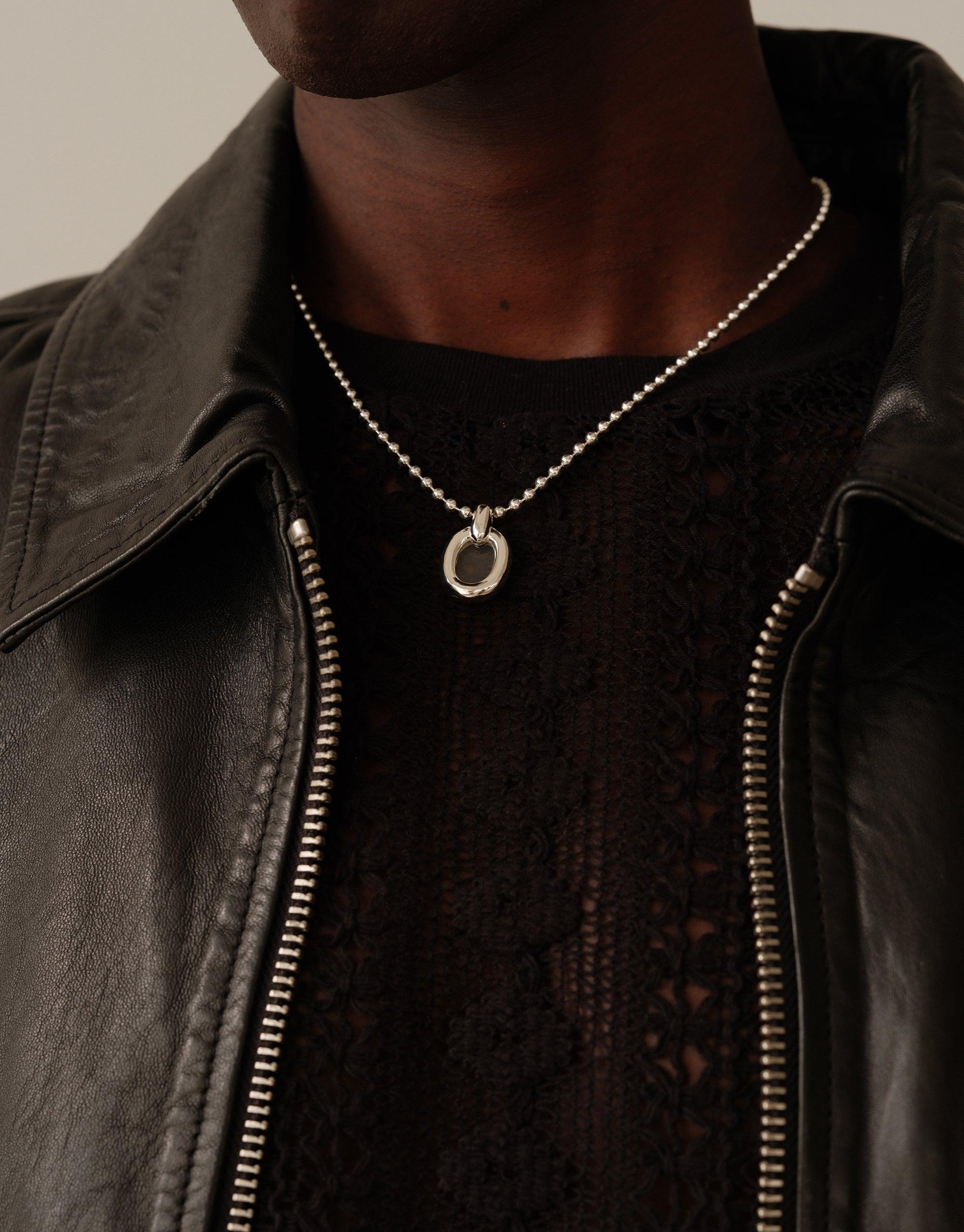 Stylish Core Loop Necklace with Ball Chain worn over black top and leather jacket, showcasing minimalist design and versatile appeal. Sustainable jewelry symbolizing unity and upcycling. Core Loop Necklace | Ball Chain by CLED