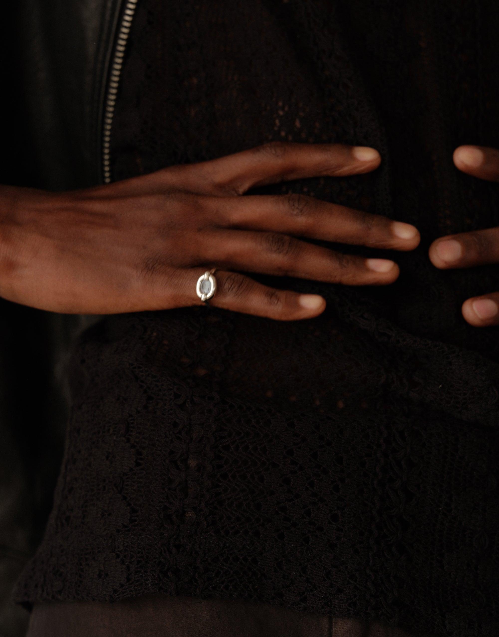 Elegant Core Loop Ring | Small on a hand, showcasing its minimalist design against a dark background. Symbolizes unity and upcycling, reflecting CLED's commitment to sustainable jewelry craftsmanship.