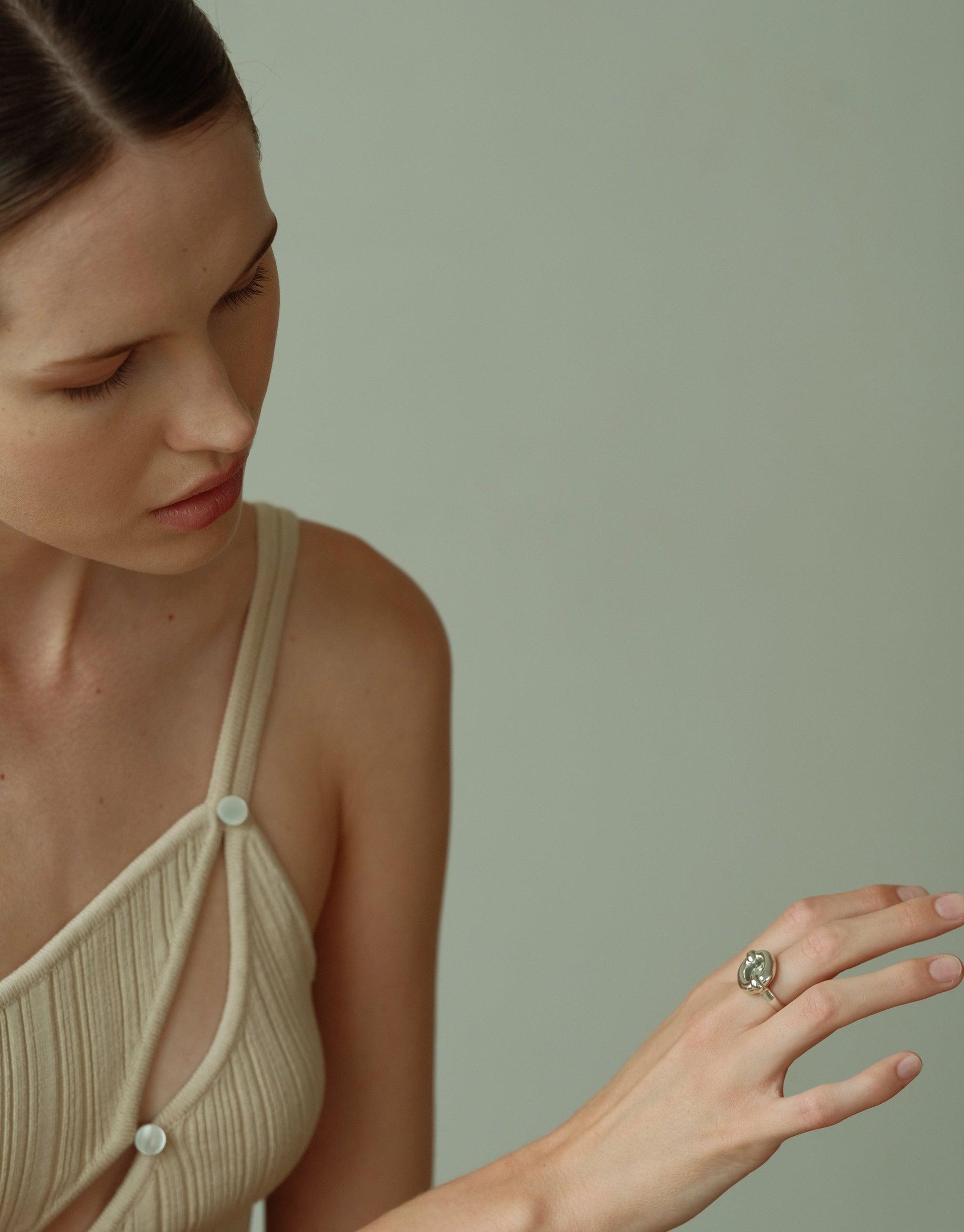 Elegant model showcasing Core Loop Ring | Large, featuring a seamless metal setting with eco gem accent and functional mirror surface. Unique design for both style and practicality by CLED.