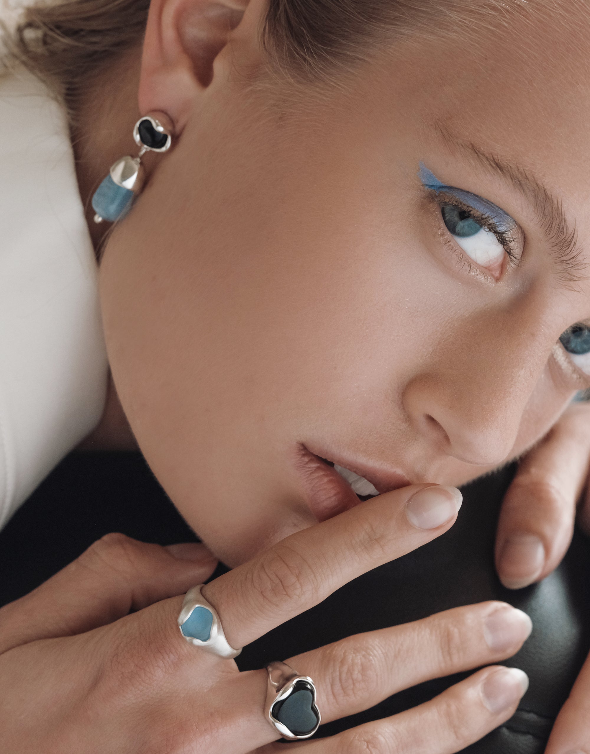 Modern Solace Drop Earrings with organic glass drops in blue and black, paired with matching rings by CLED