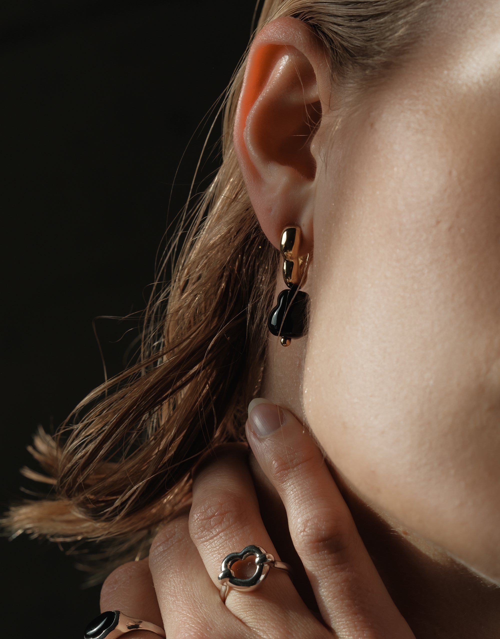 Flow Drop Hoop Earrings with organic glass pendant and gold-toned hoops, styled with matching ring in moody lighting - CLED