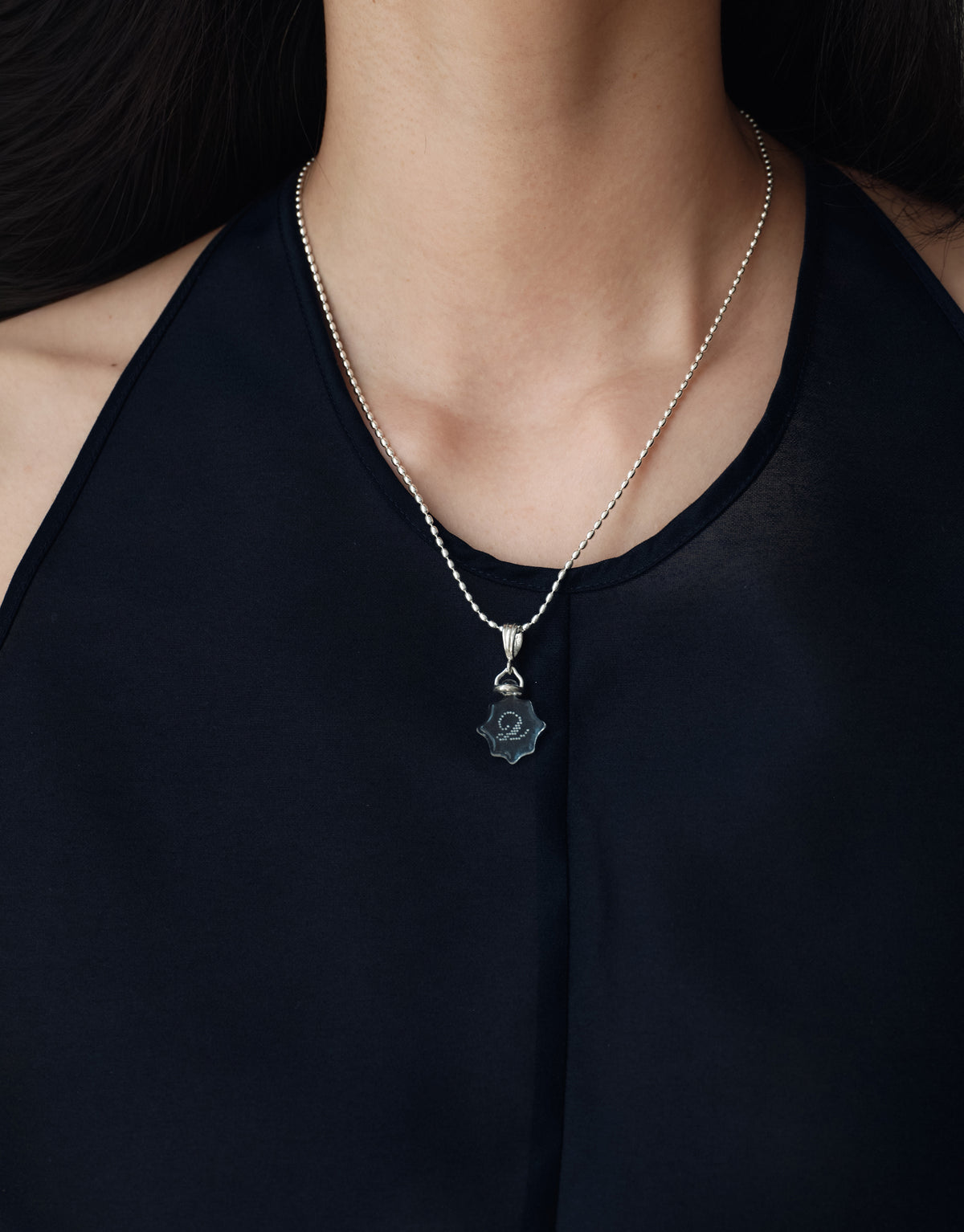 LAS Scallop Pendant worn on the model, upcycled glass Eco Gem set in sterling silver. Handmade in Los Angeles. LAS Scallop Pendant by CLED.