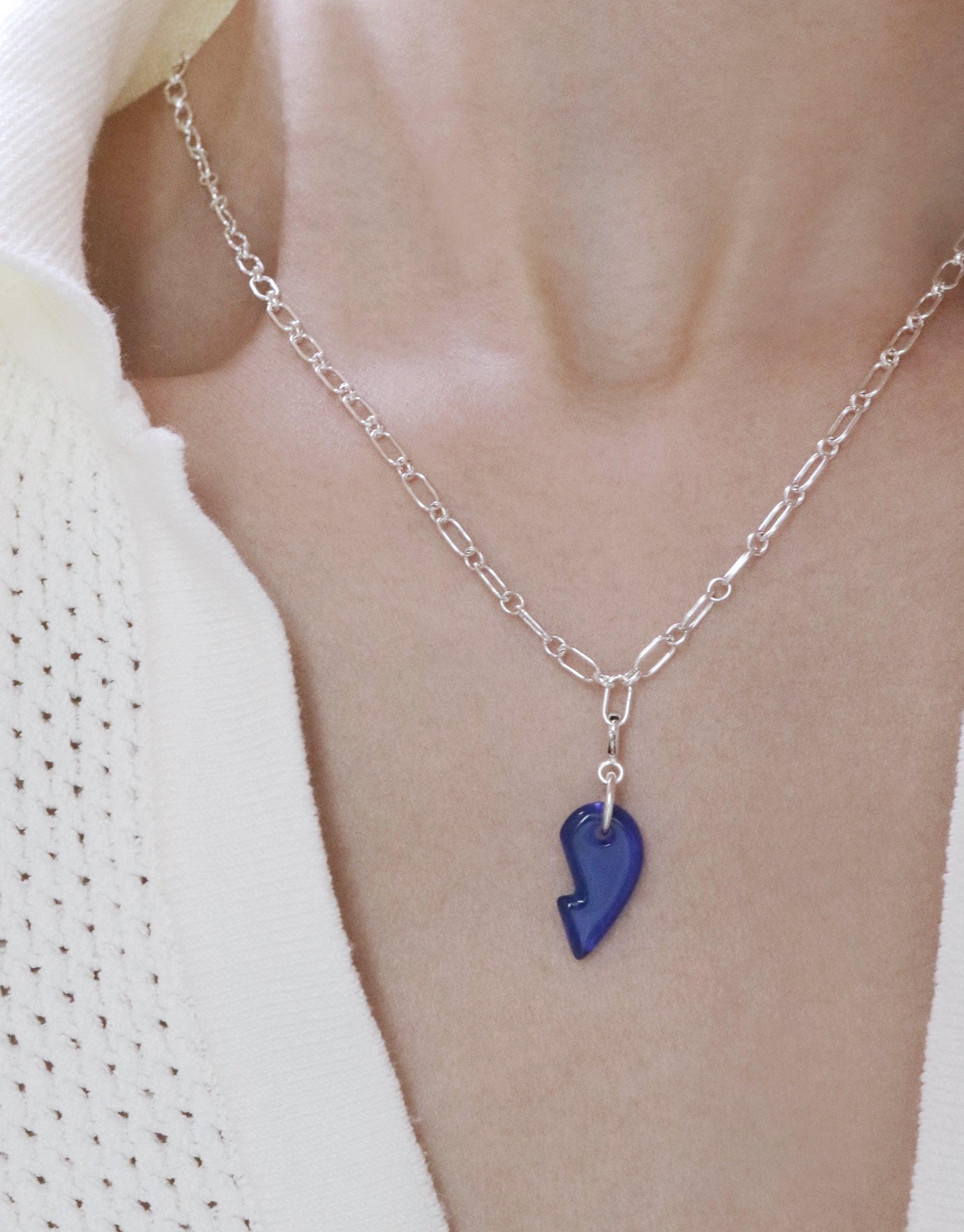 Split Heart | Icon Charm displayed on a woman's neck, showcasing a sterling silver pendant crafted from upcycled glass, embodying unity and connection. Chain not included, highlighting CLED's eco-conscious craftsmanship.