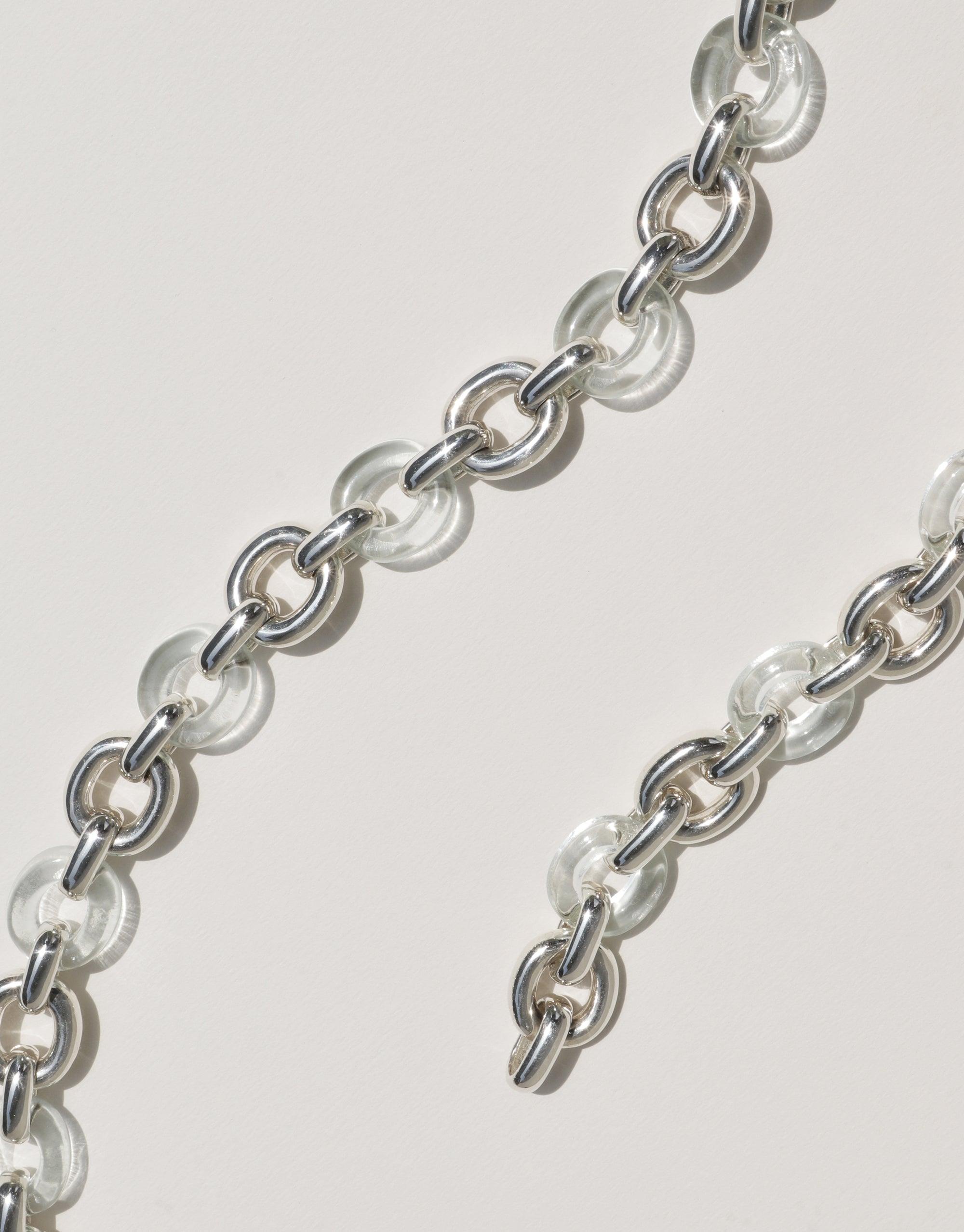 Connected Loop Bracelet featuring alternating clear glass and silver metal links, symbolizing unity and upcycling. Elegant chain design showcases sustainable jewelry craftsmanship. Connected Loop Bracelet | Mixed Metal & Glass by CLED