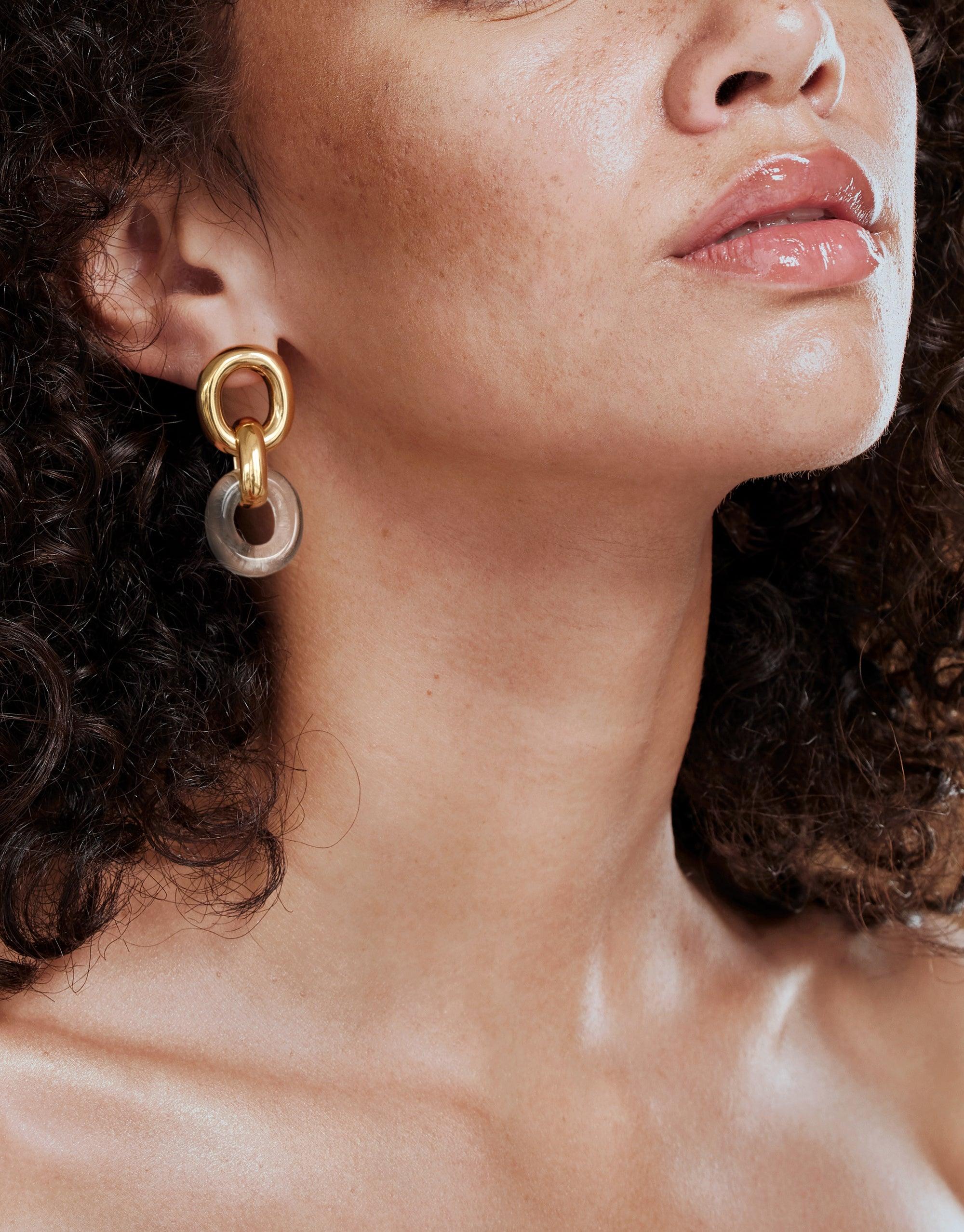 Close-up of a model wearing Connected Loop Earrings, featuring gold and silver interlocking circular design, showcasing the upcycled elegance of the In The Loop collection by CLED