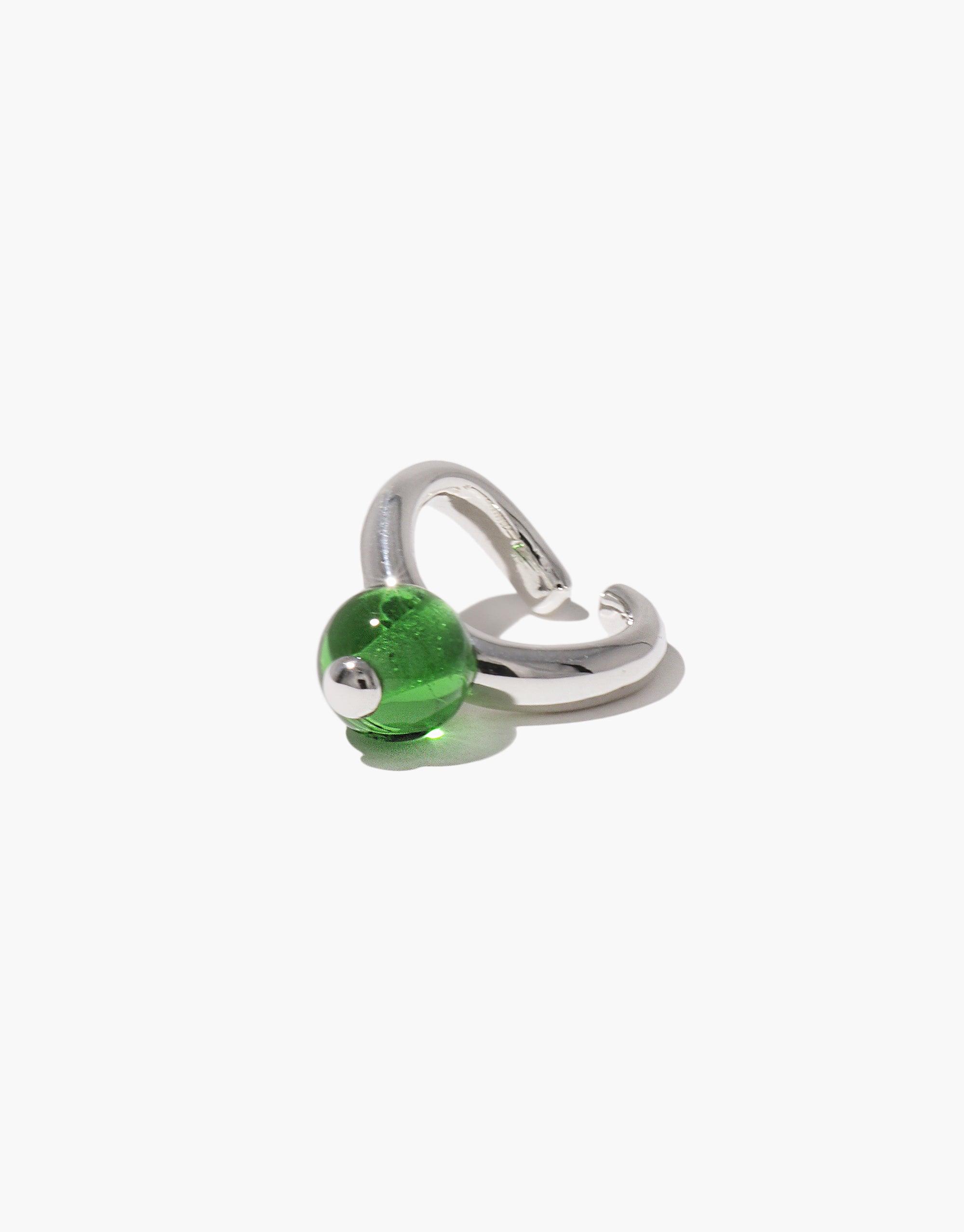 Elegant silver ear cuff featuring a vibrant green spherical accent, inspired by nature's organic shapes. Pea Ear Cuff | Large showcases a unique blend of contemporary design and natural aesthetics. CLED