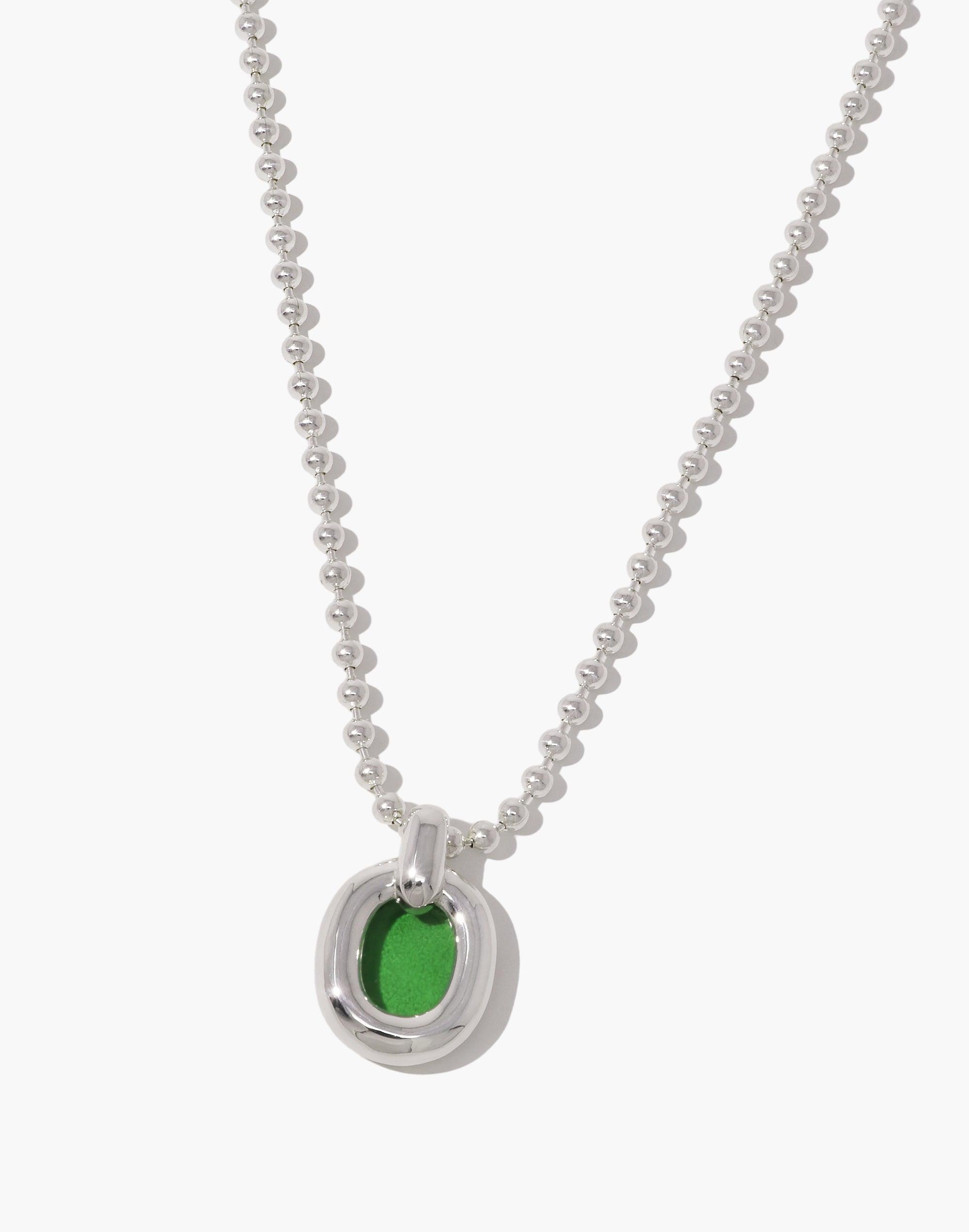 Elegant silver ball chain necklace featuring a circular pendant with vibrant green accent, symbolizing unity and sustainability. Core Loop Necklace by CLED, showcasing upcycled materials in a sleek, modern design. Ball Chain Necklace embodying connection and eco-conscious fashion. CLED