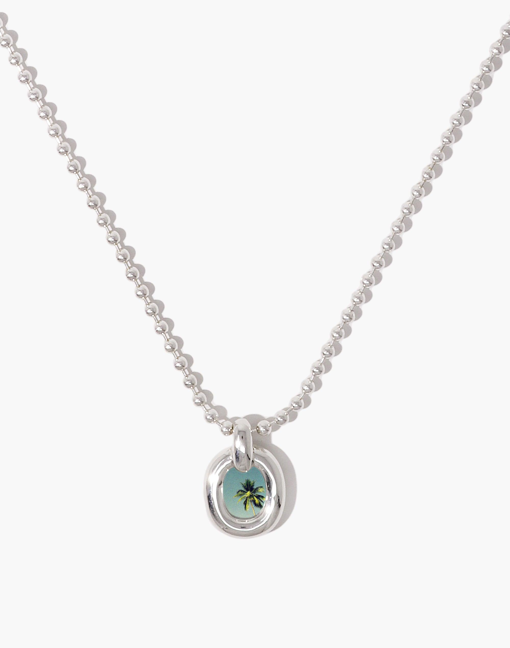 Elegant silver ball chain necklace with circular pendant featuring a small turquoise-colored charm, symbolizing unity and upcycling. Core Loop Necklace | Ball Chain showcases CLED's commitment to sustainable jewelry design.