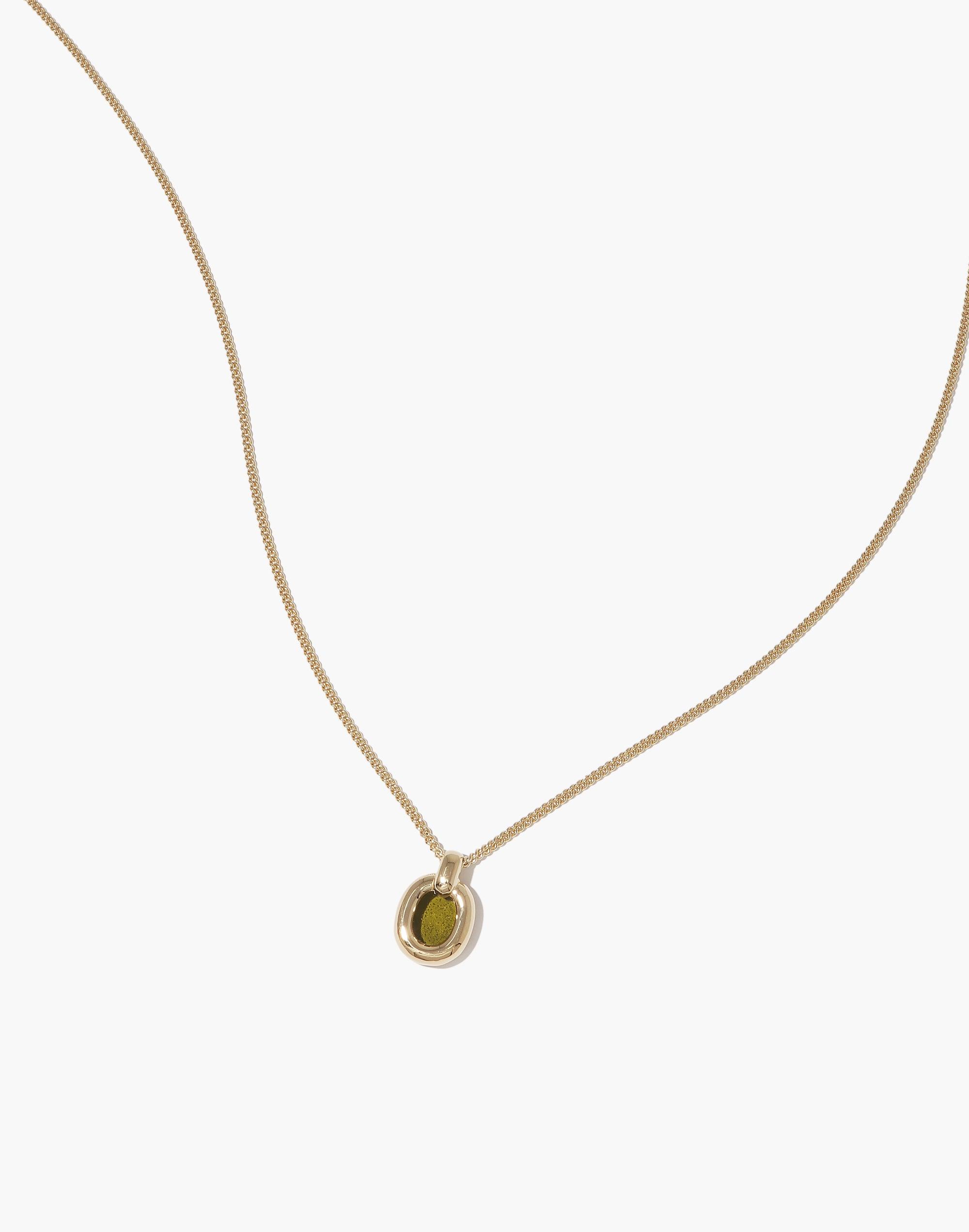 Elegant Small Core Loop Necklace featuring a delicate gold chain with a unique circular pendant. The pendant showcases a green upcycled glass element, embodying sustainable luxury. Perfect for everyday wear, this necklace symbolizes unity and environmental consciousness. Small Core Loop Necklace by CLED