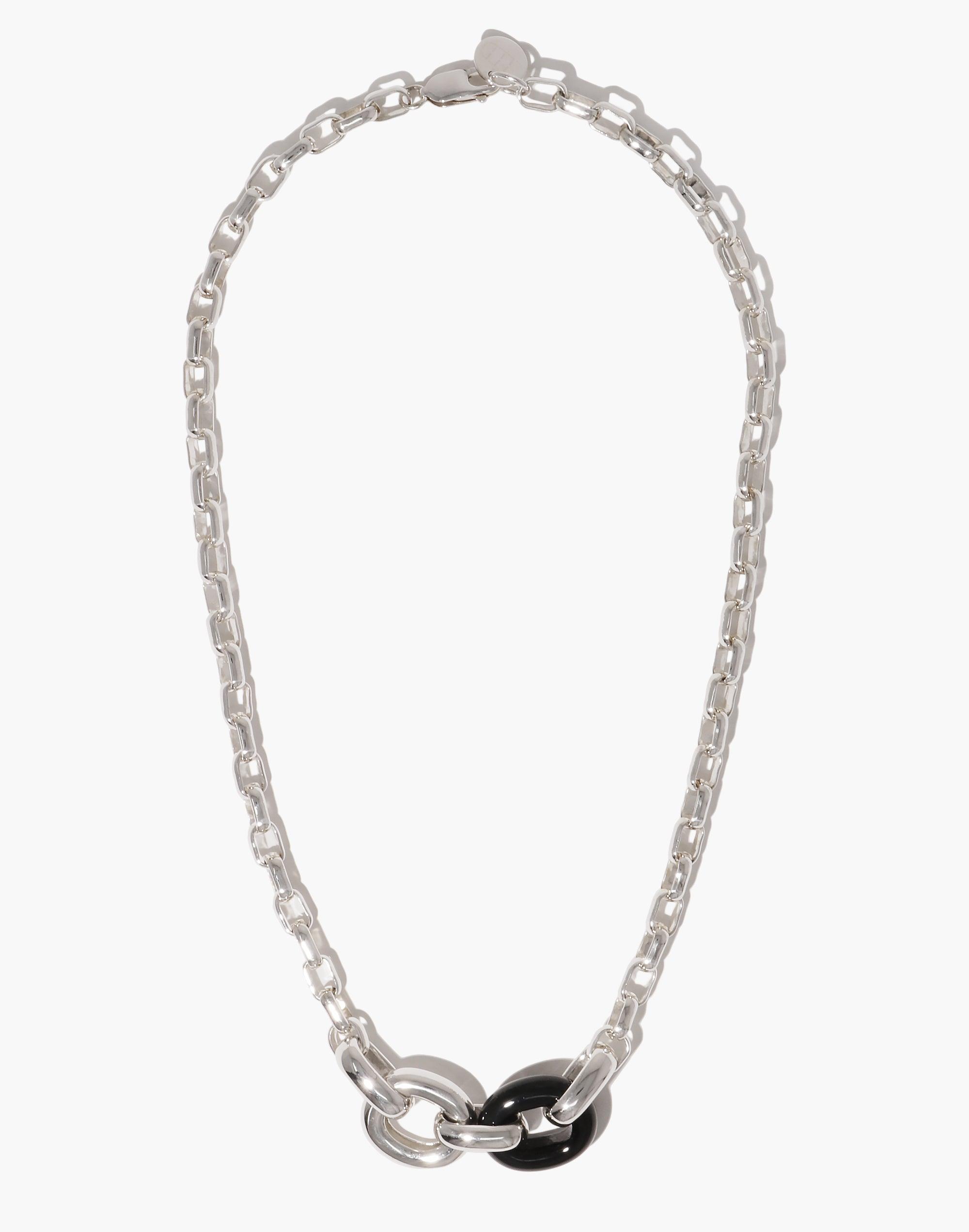 Elegant silver chain necklace with interlocking loops, featuring a striking black and silver pendant. Symbolizes unity and upcycling. Loop Chain Necklace by CLED.