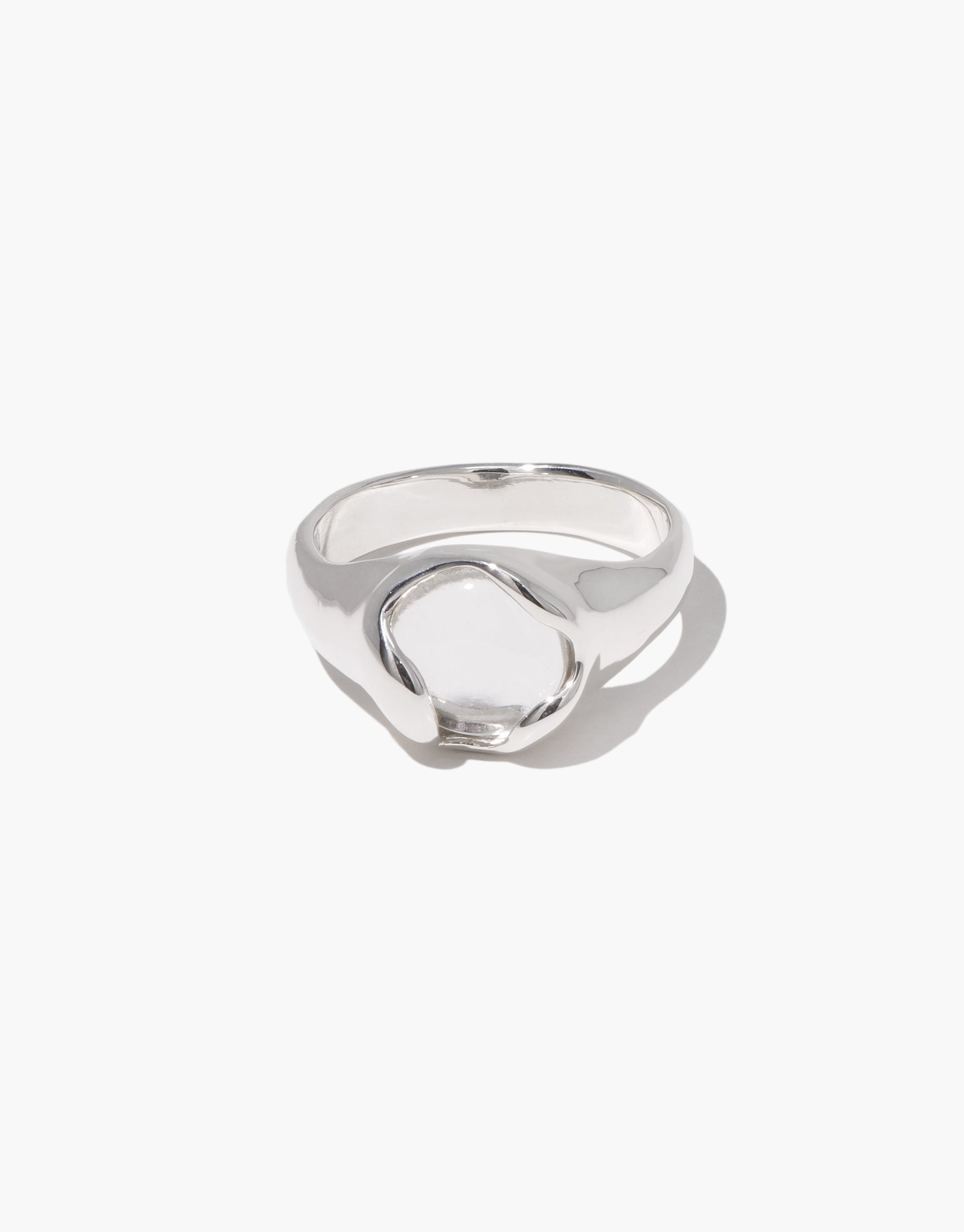 Orb Ring featuring smooth silver curves embracing a clear recycled glass centerpiece in a modern minimal design by CLED