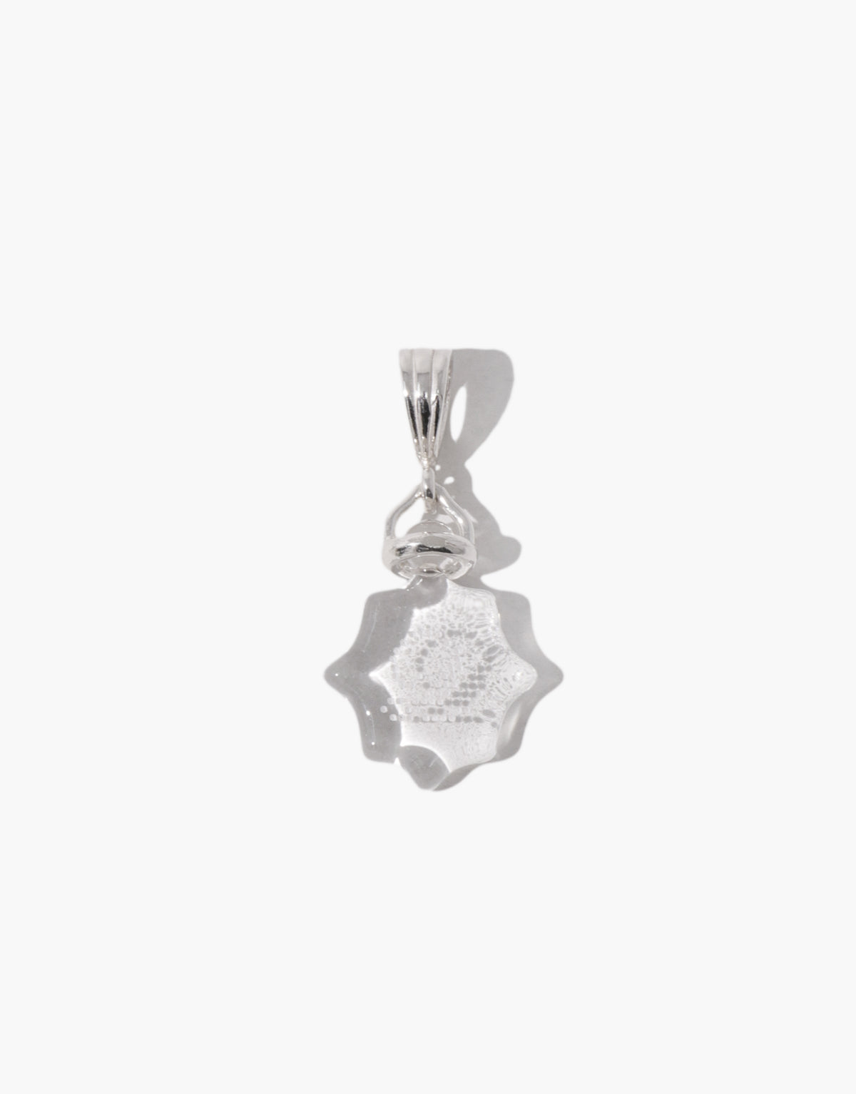 Las Pendant | Scallop in clear glass with a soft scalloped lace edge, hanging from a slim sterling silver bail. Las Pendant | Scallop by CLED.