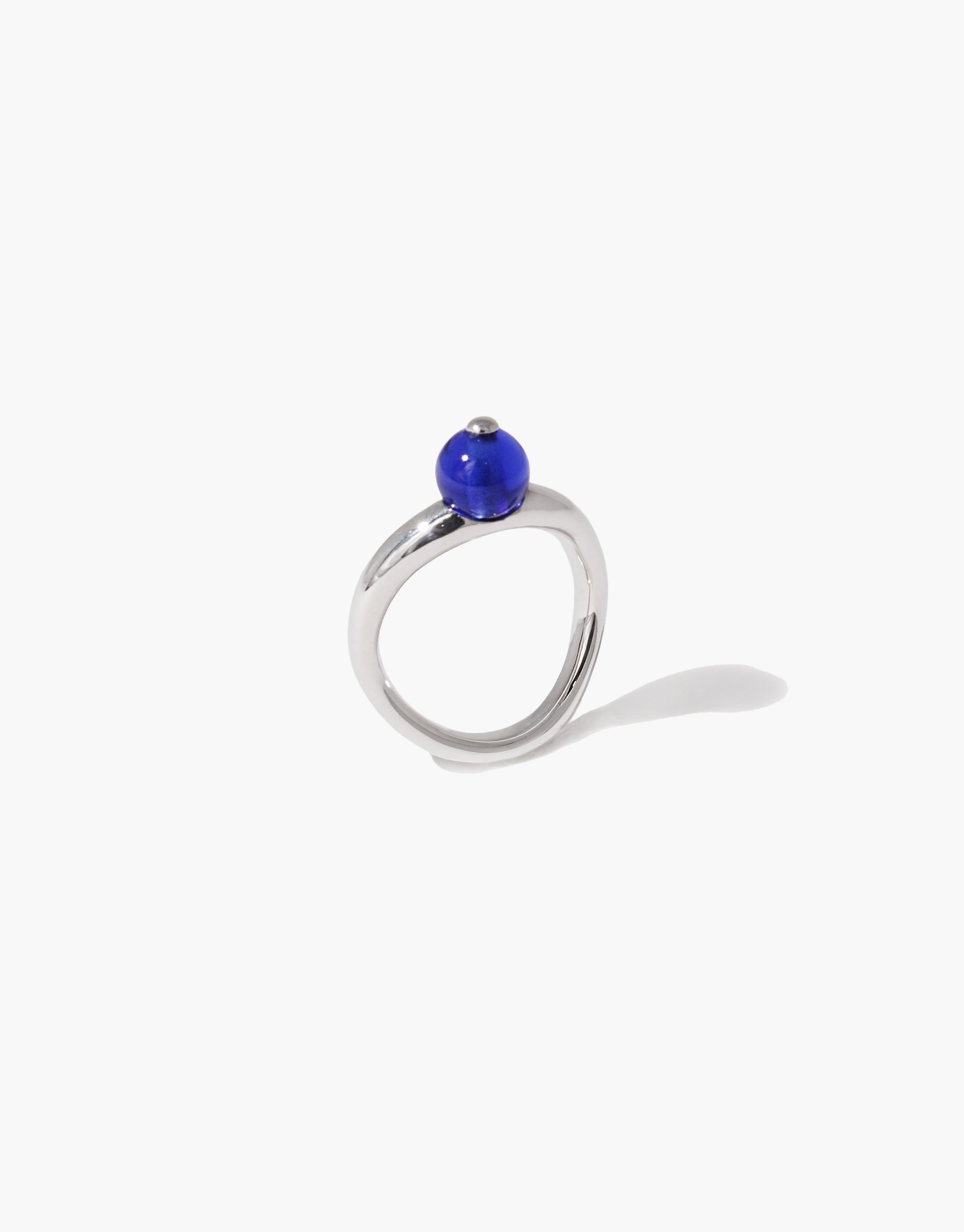 Elegant silver ring featuring a vibrant blue sphere, inspired by nature's organic shapes and curves. The Pea Curve Ring | Small showcases a minimalist design with a unique twist, perfect for everyday wear. A stunning piece that embodies growth and transformation. CLED