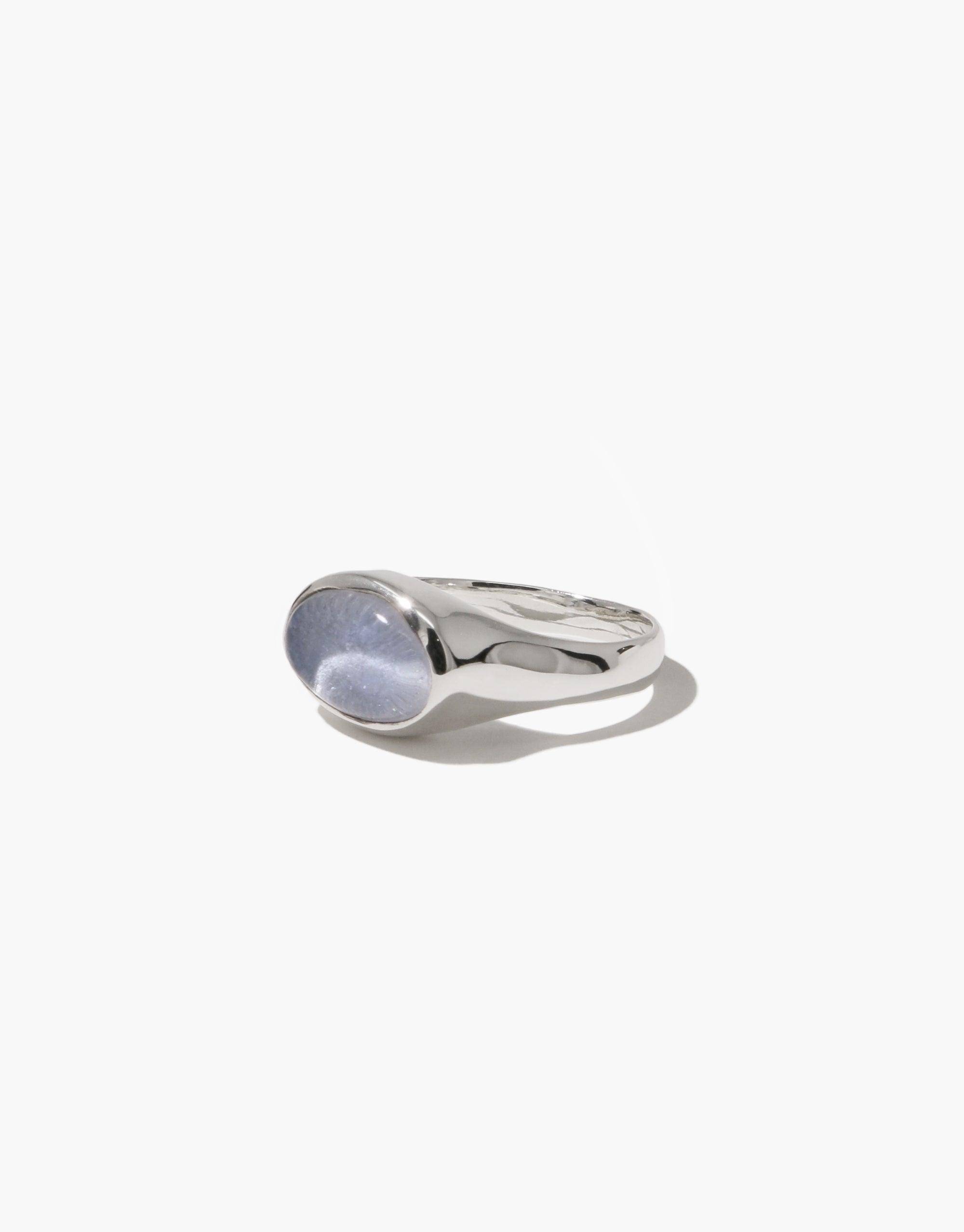 Oval Sculpture Ring featuring a sleek silver band with a unique oval-shaped clear glass centerpiece, showcasing eco-friendly elegance and modern design. Handcrafted from upcycled glass bottles, this versatile ring adds a touch of sustainable sophistication to any outfit. CLED